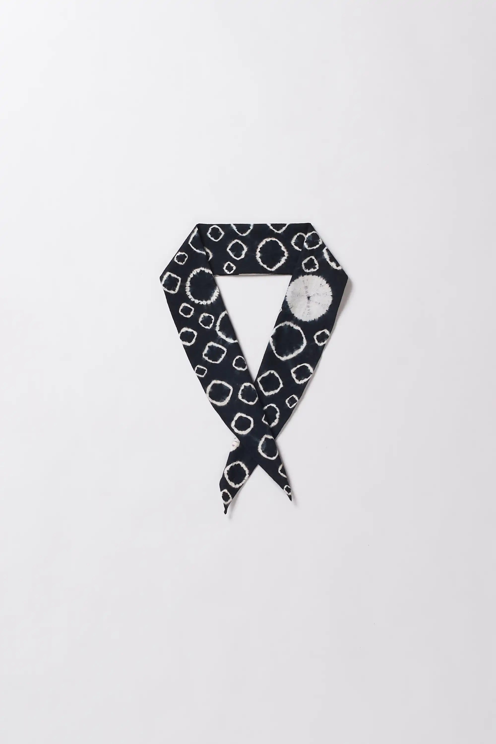 Black and white patterned scarf on a light gray background