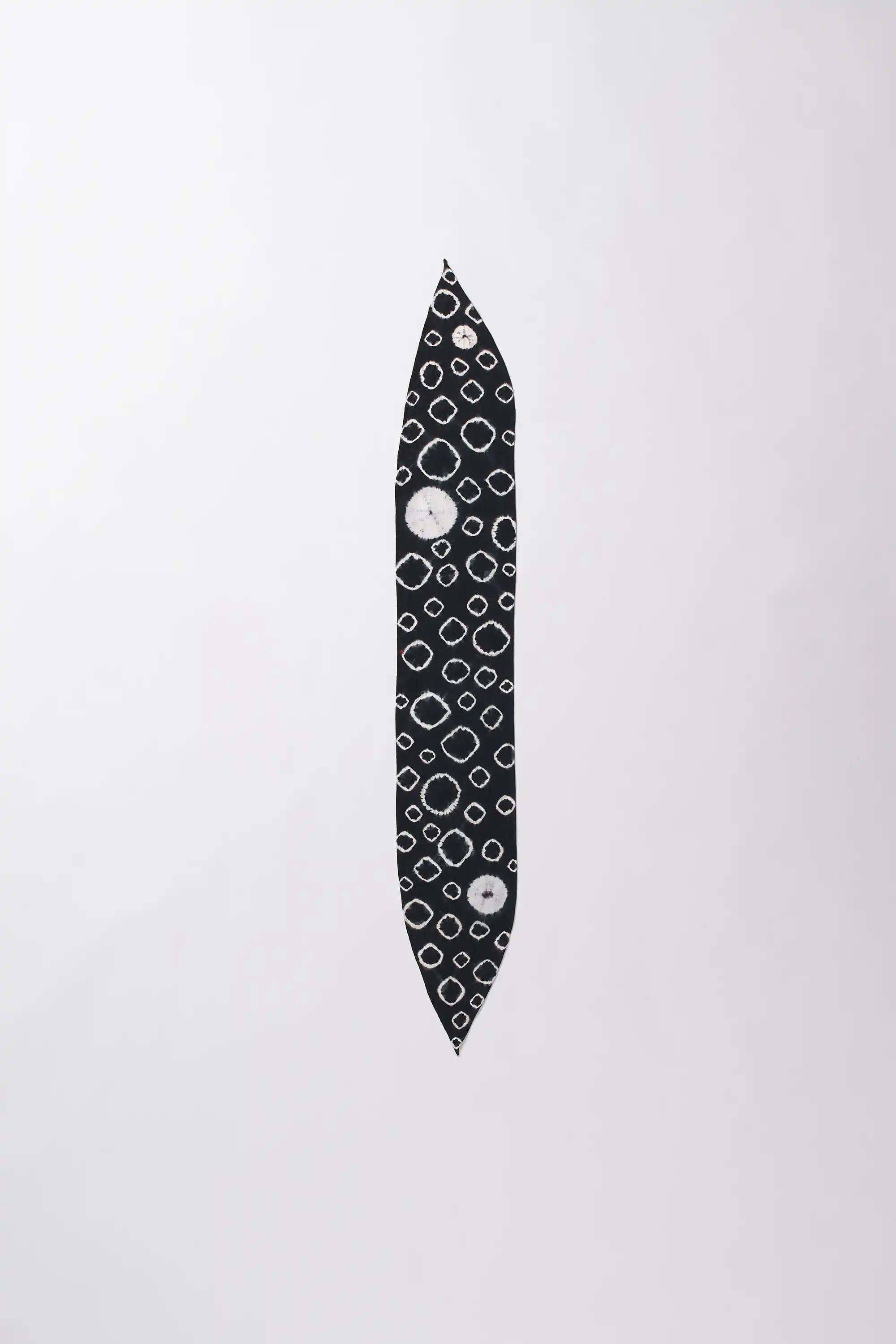Black and white patterned object on a light gray background