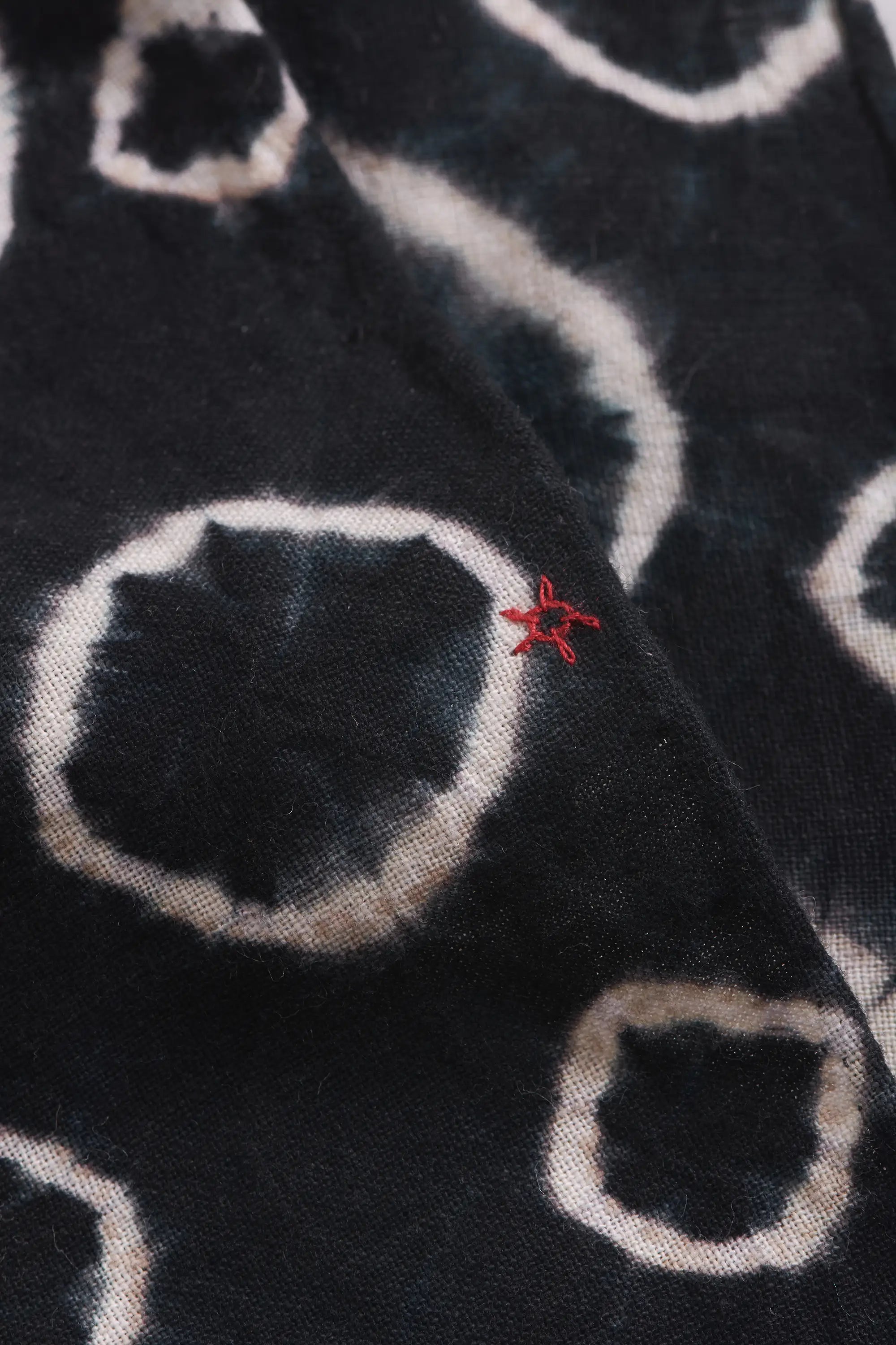 Fabric close-up with shibori and small red pehchan