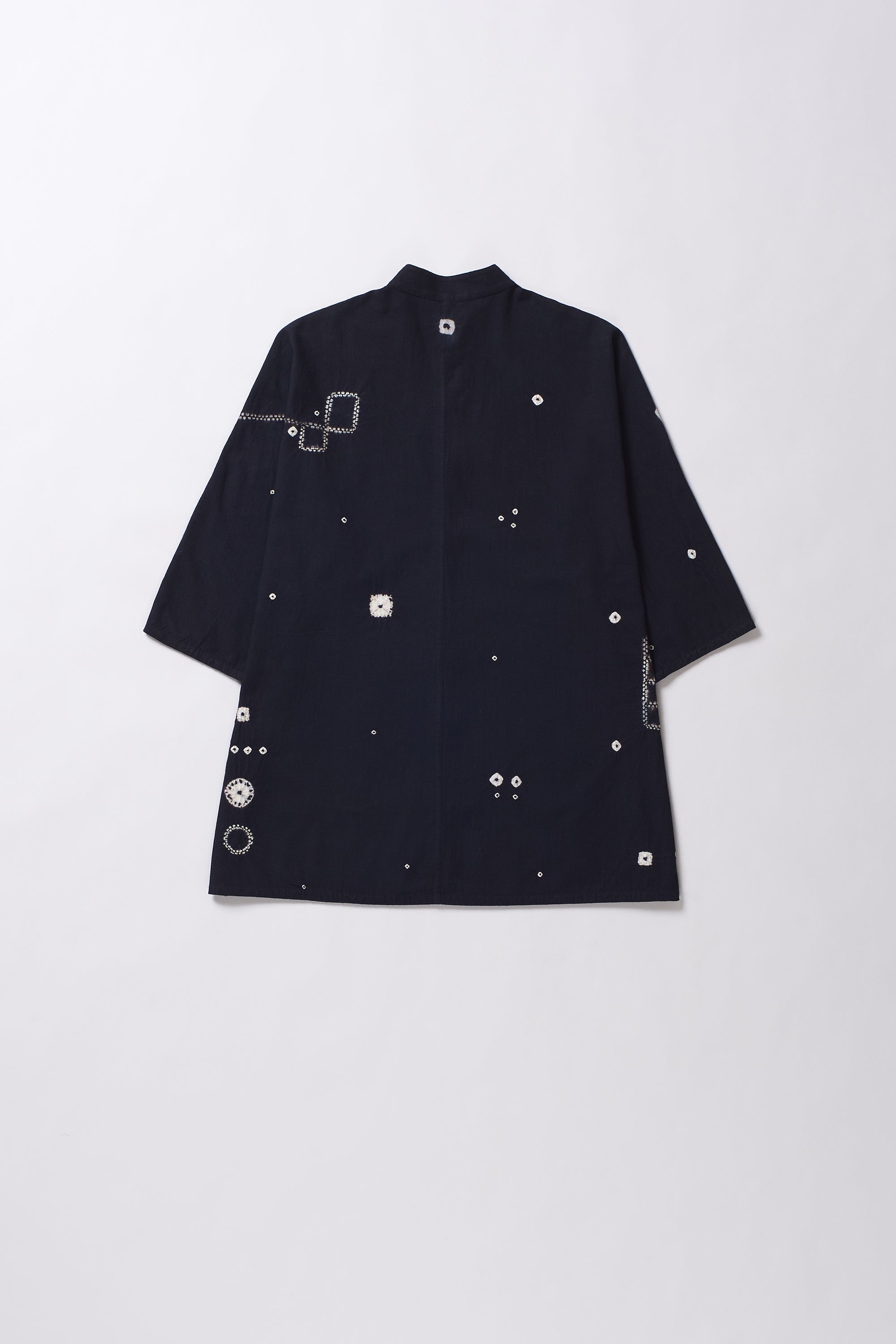 Black shirt with shibori work on a light grey background