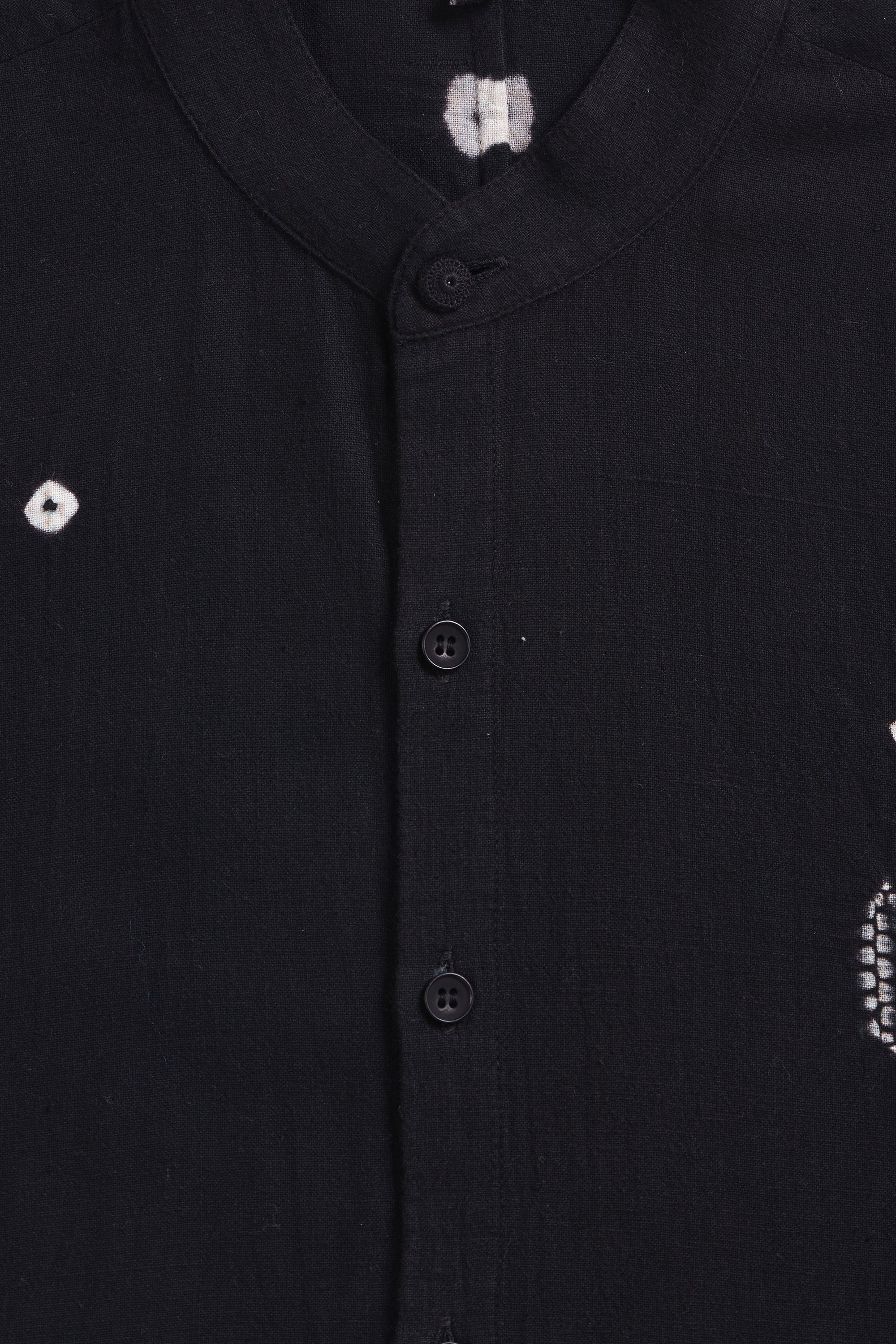 Close-up of a black shirt with white patterns on buttons