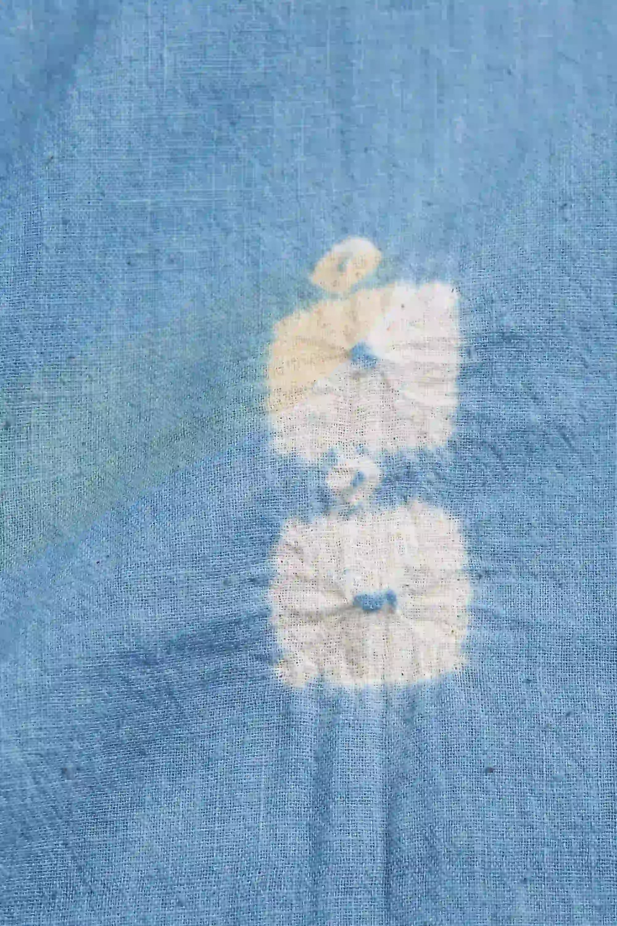 Blue denim fabric with a white floral pattern