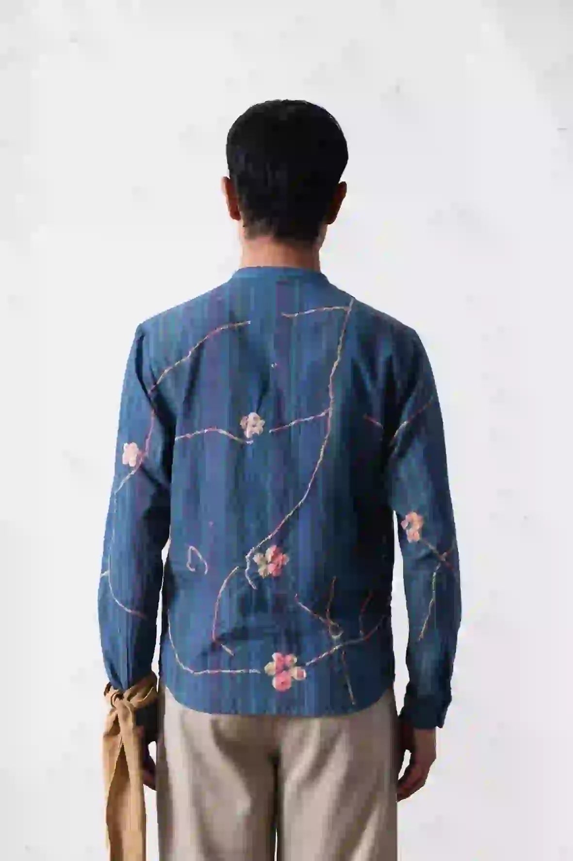 A back shot of man wearing sky indigo shirt