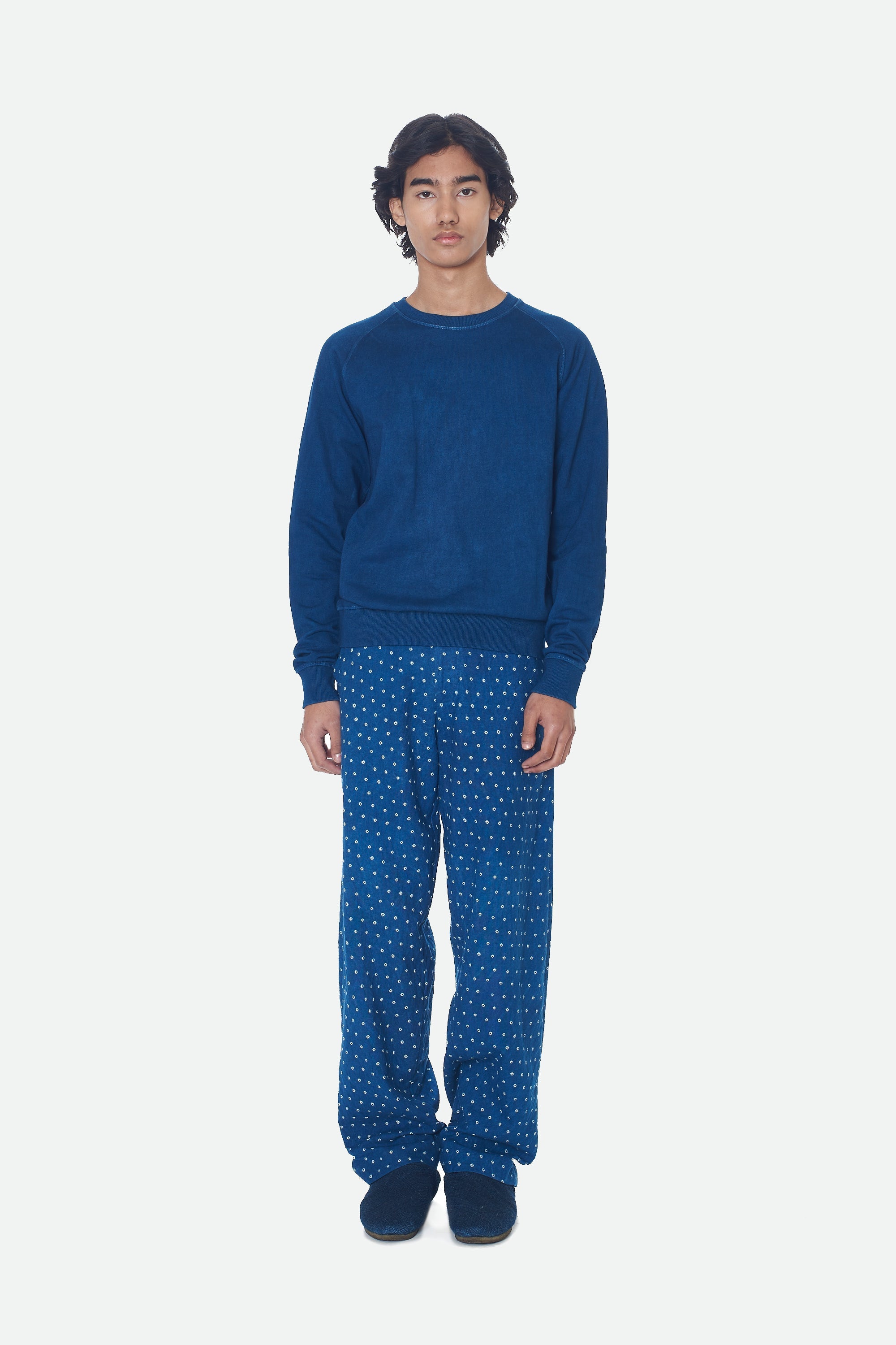 A man wearing medium indigo sweatshirt