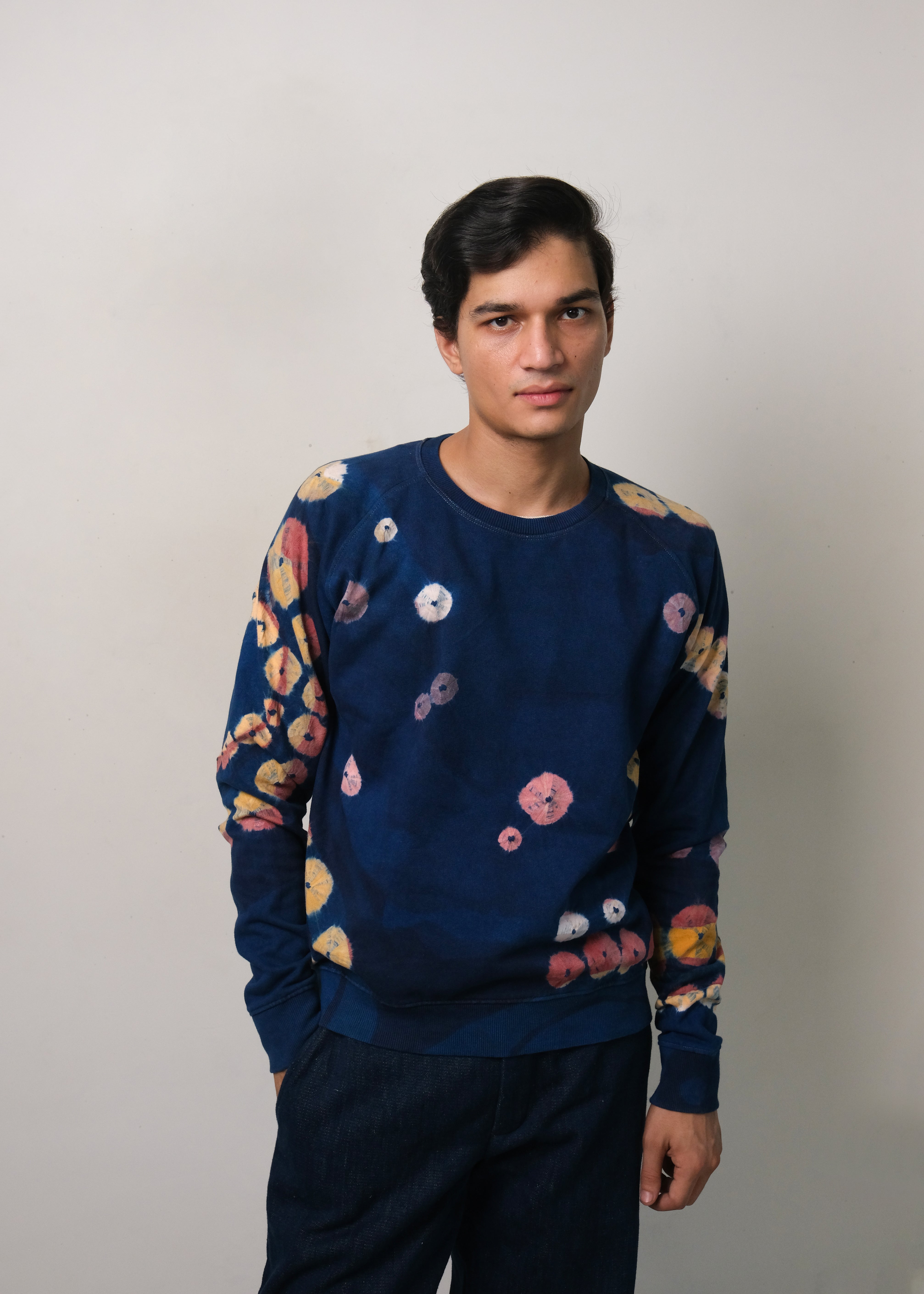 A man wearing of medium indigo handpaint bandhani sweatshirt