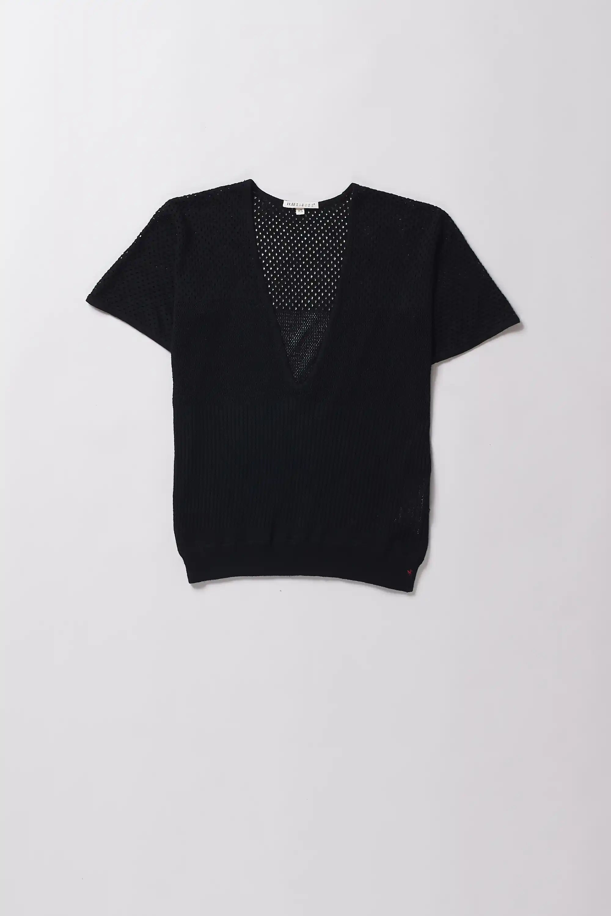 Black V-neck top with mesh detail on a light gray background