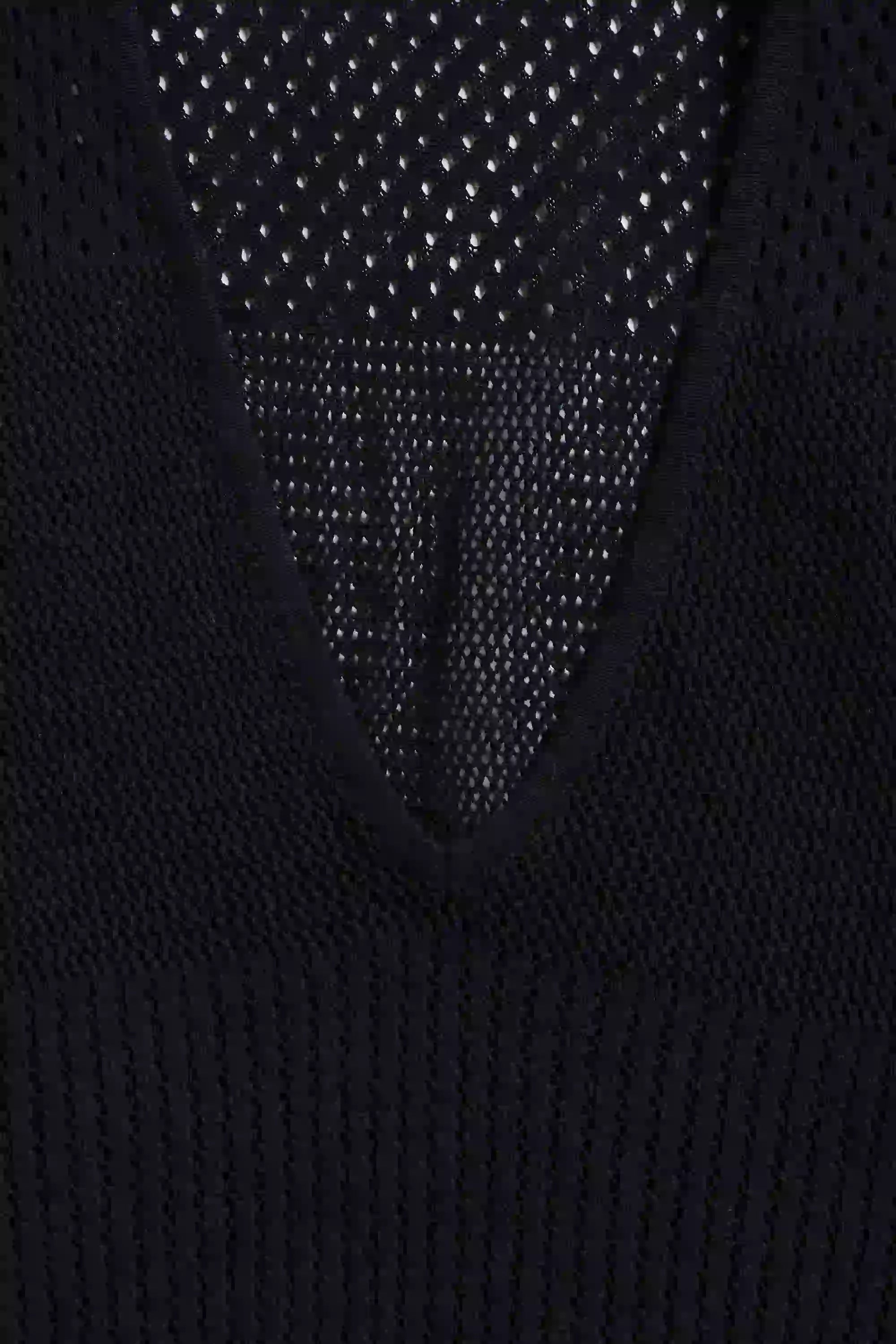 Close-up of a black textured garment with a patterned back