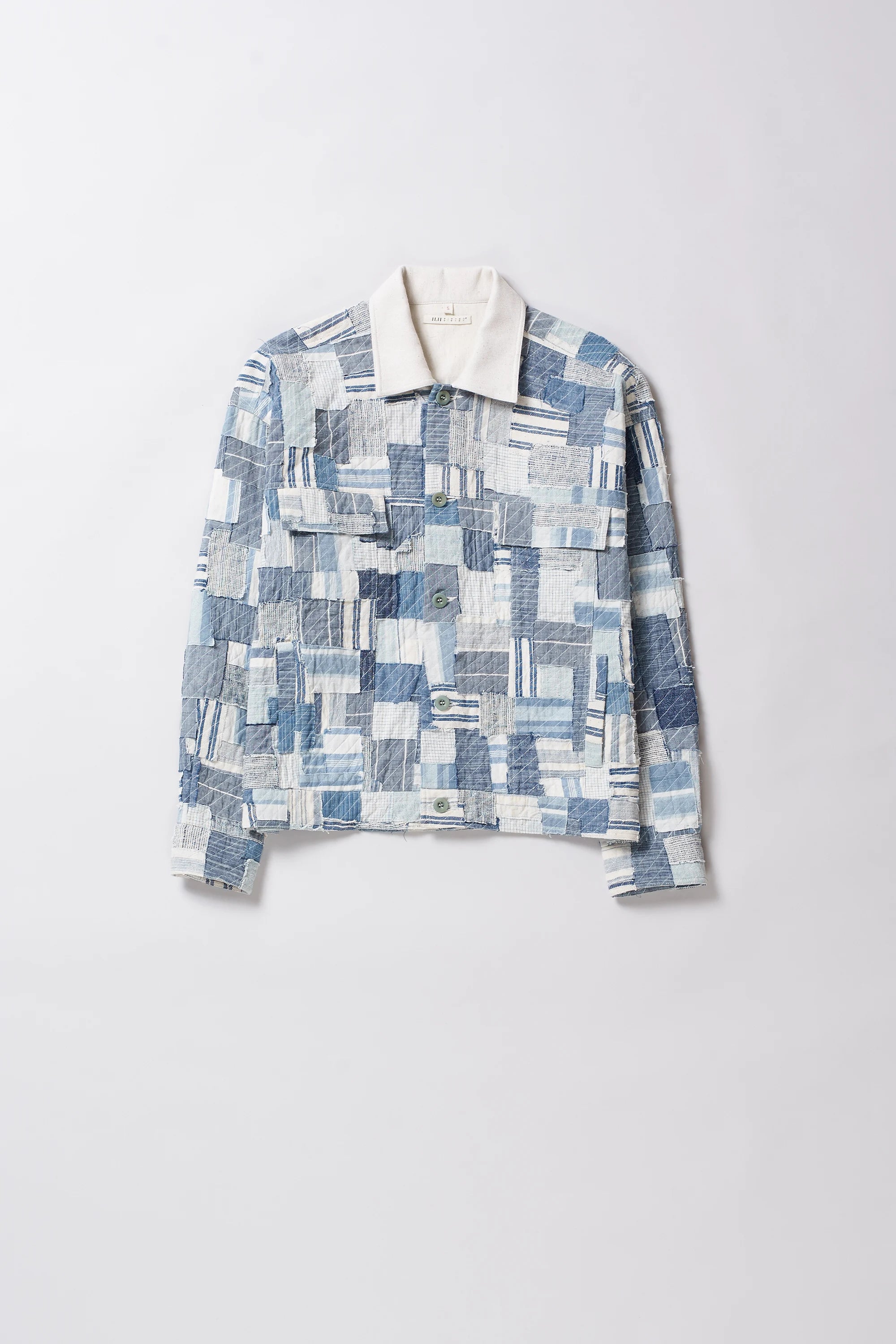 Patchwork patterned shirt on a light gray background