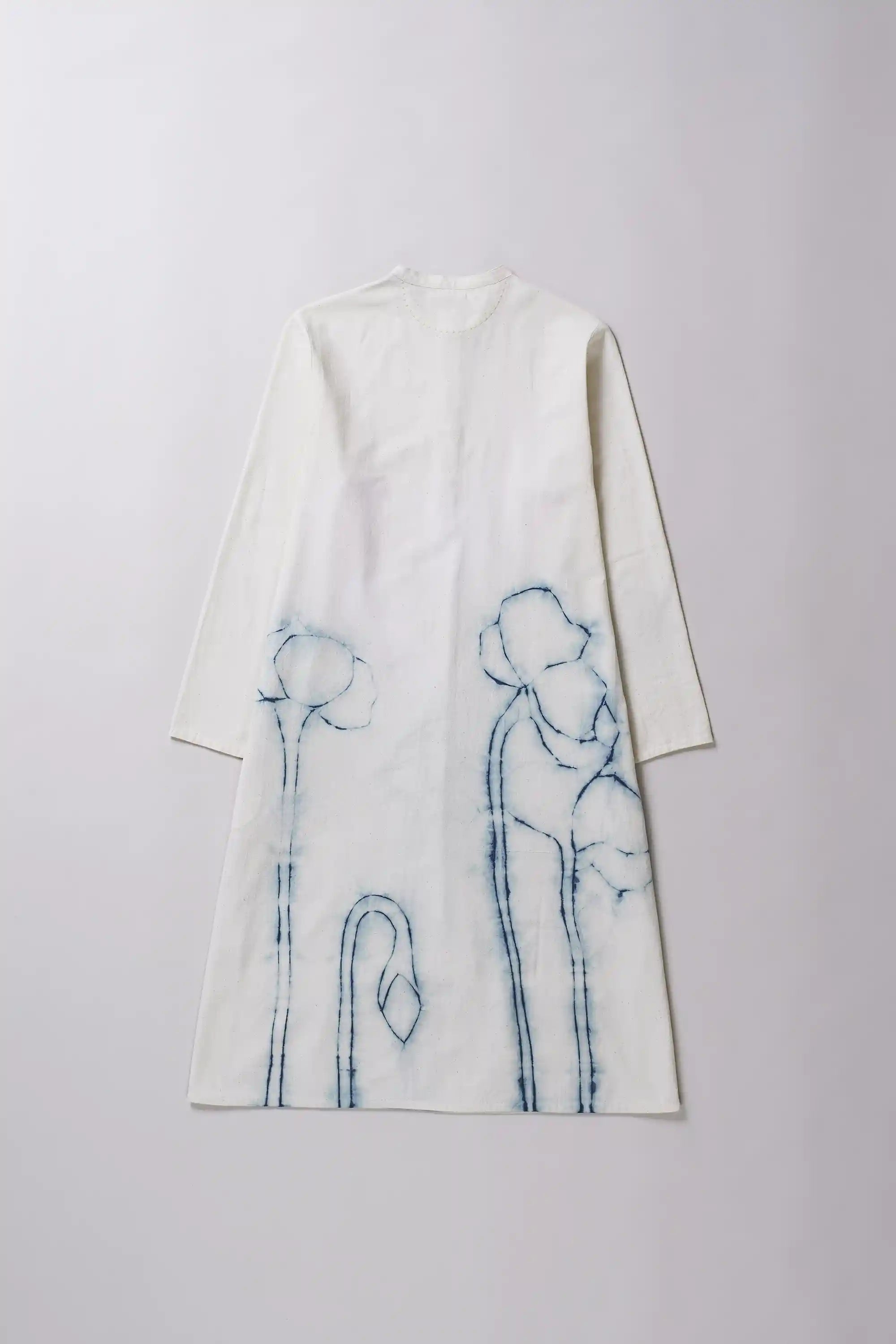 White coat with blue embroidered designs on a light gray background