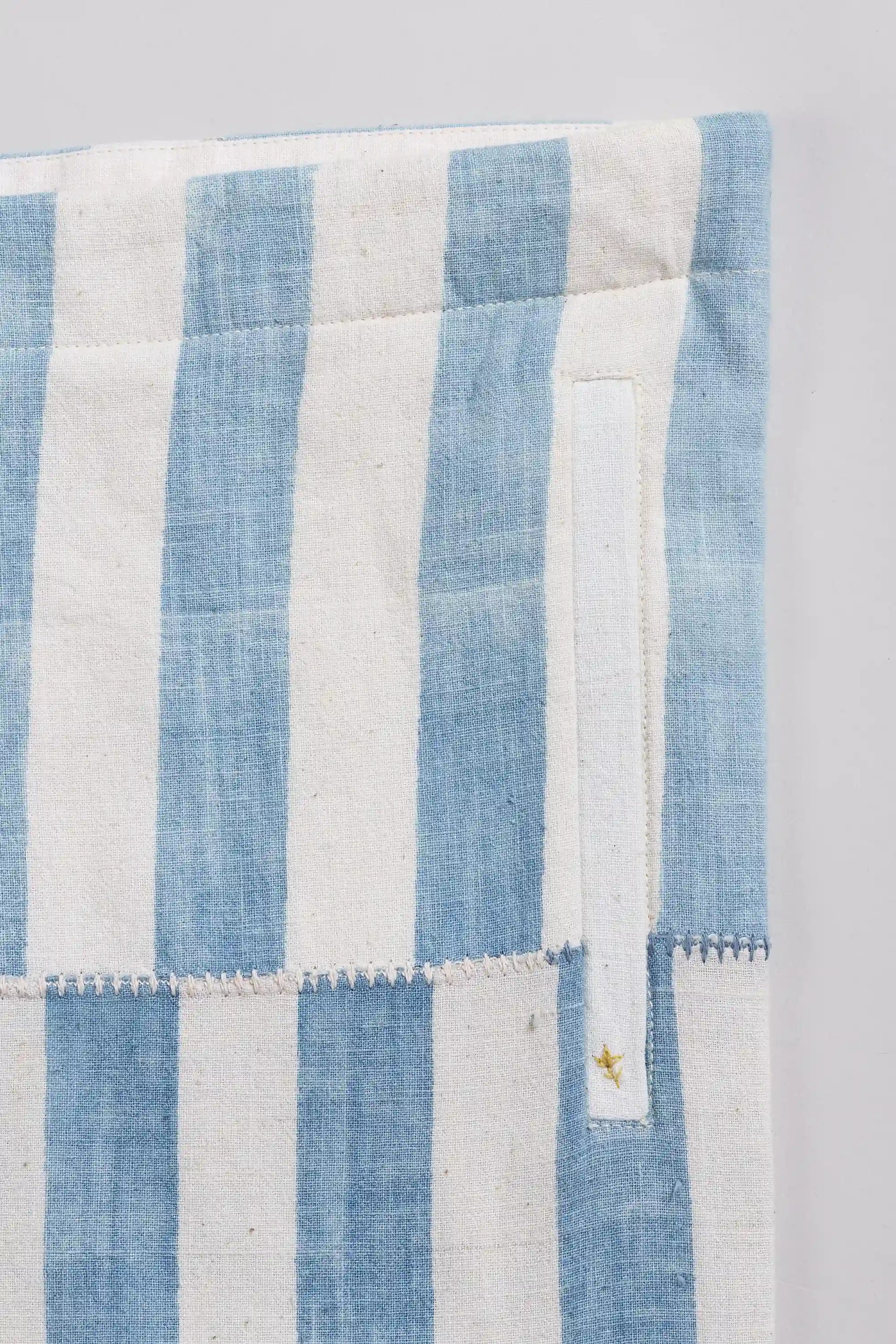 Side shot close-up with a tiny gold embroidered star is visible on the right side.