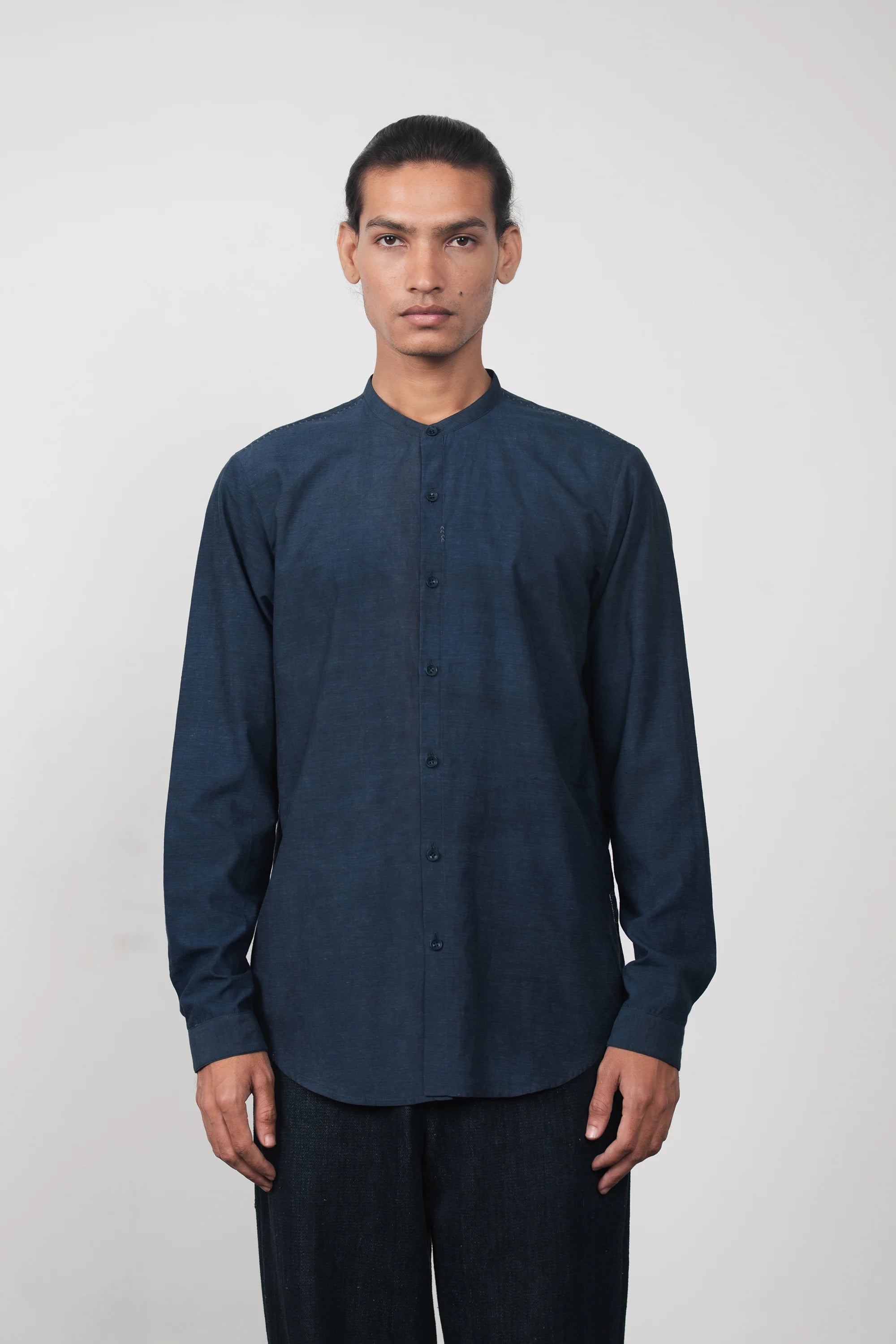 A man wearing estate blue shirt with black pant