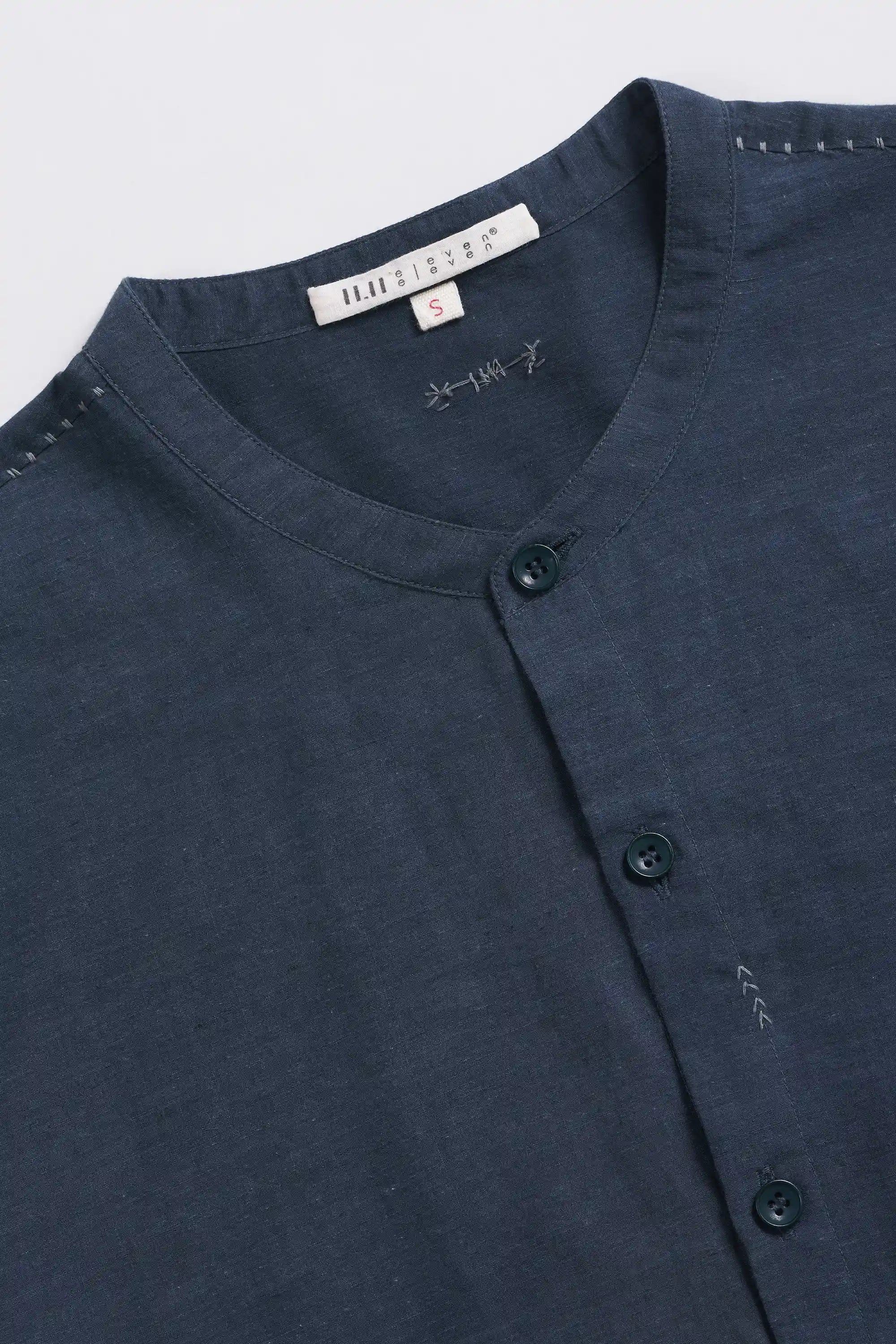 Fabric close-up with hand detailing and buttons