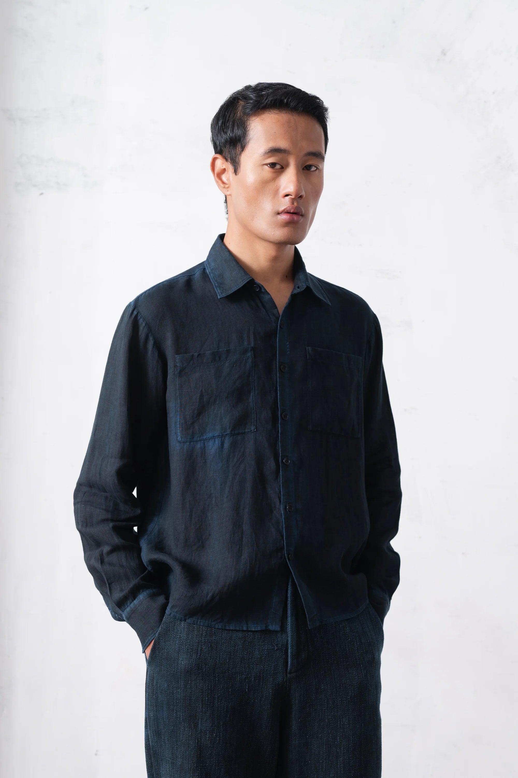 Man wearing a black shirt and pants on a white background