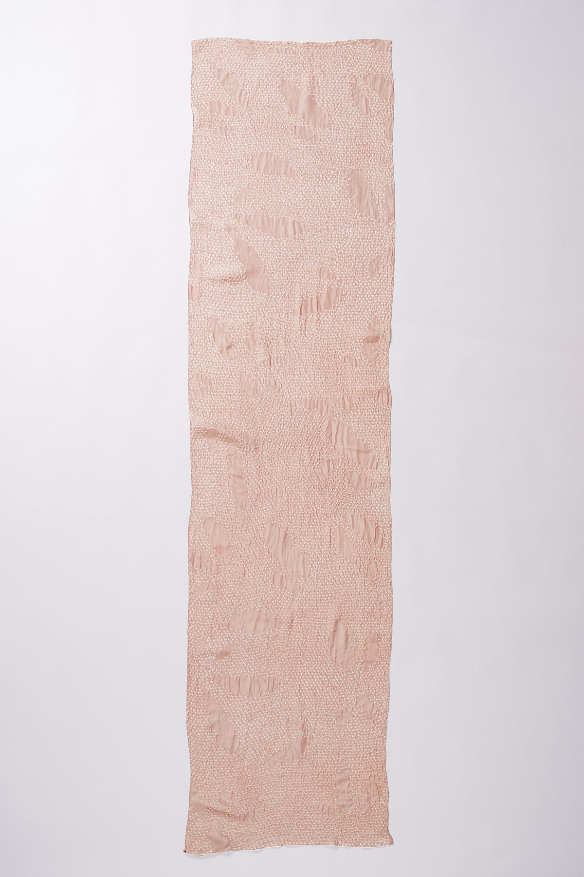 Long rectangular piece of light pink fabric