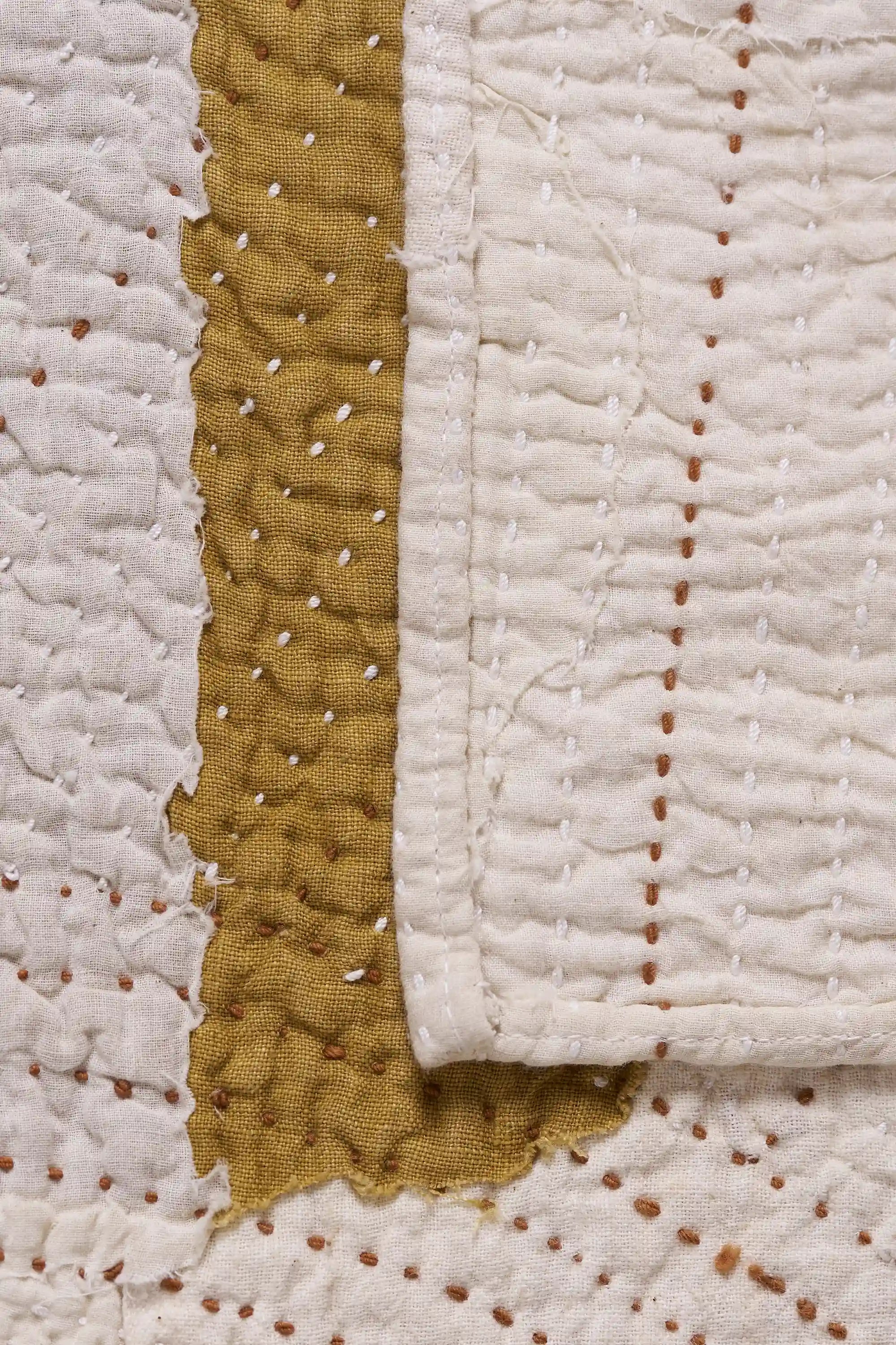 Kantha quilt with patchwork on light grey background