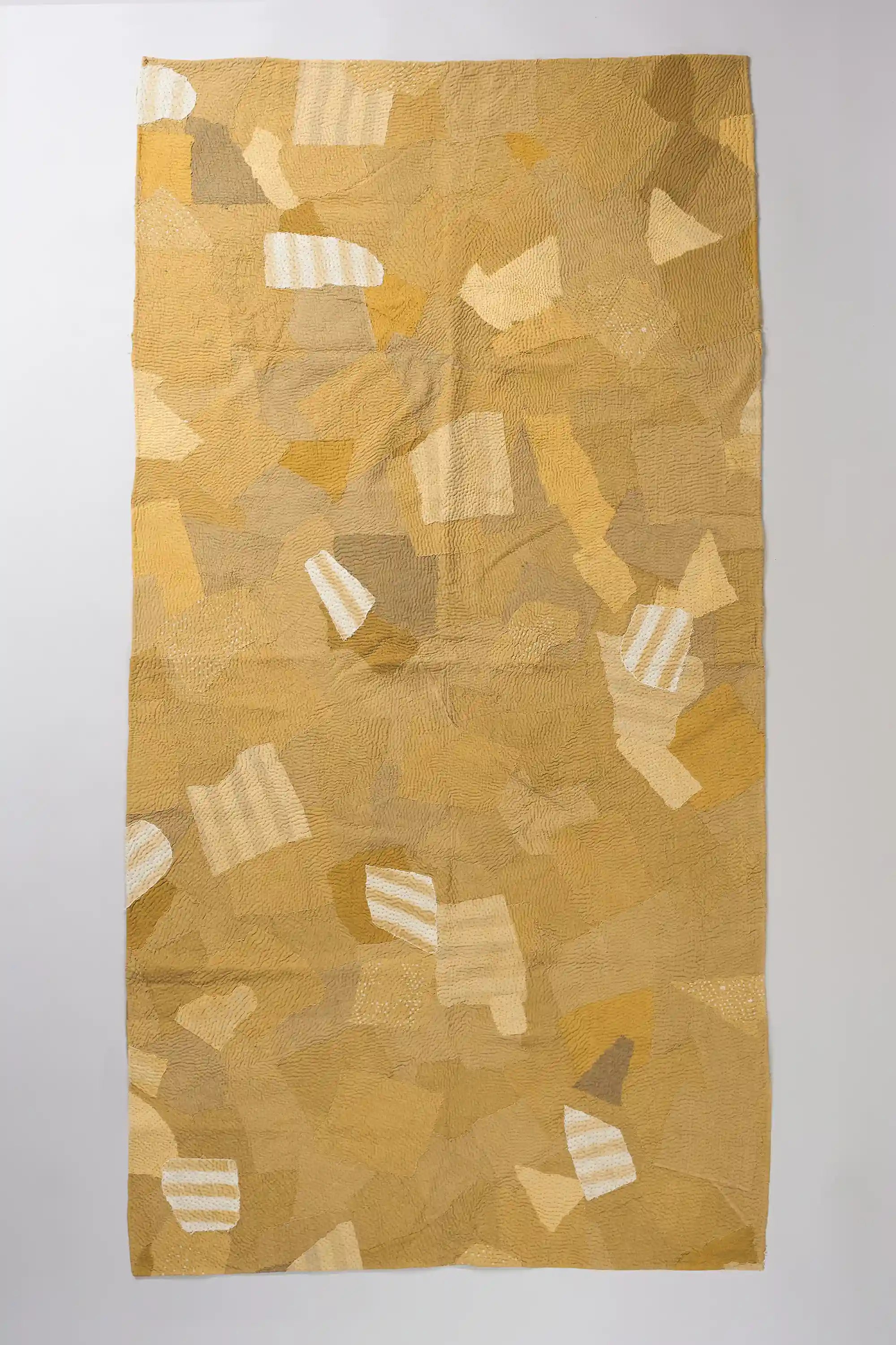 Yellow patchwork quilt in shades of yellow