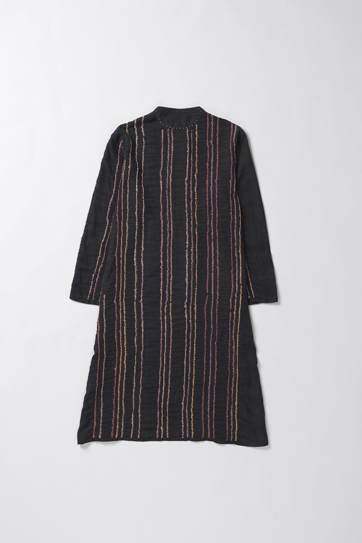 Black dress with thin red and beige stripes on a white background
