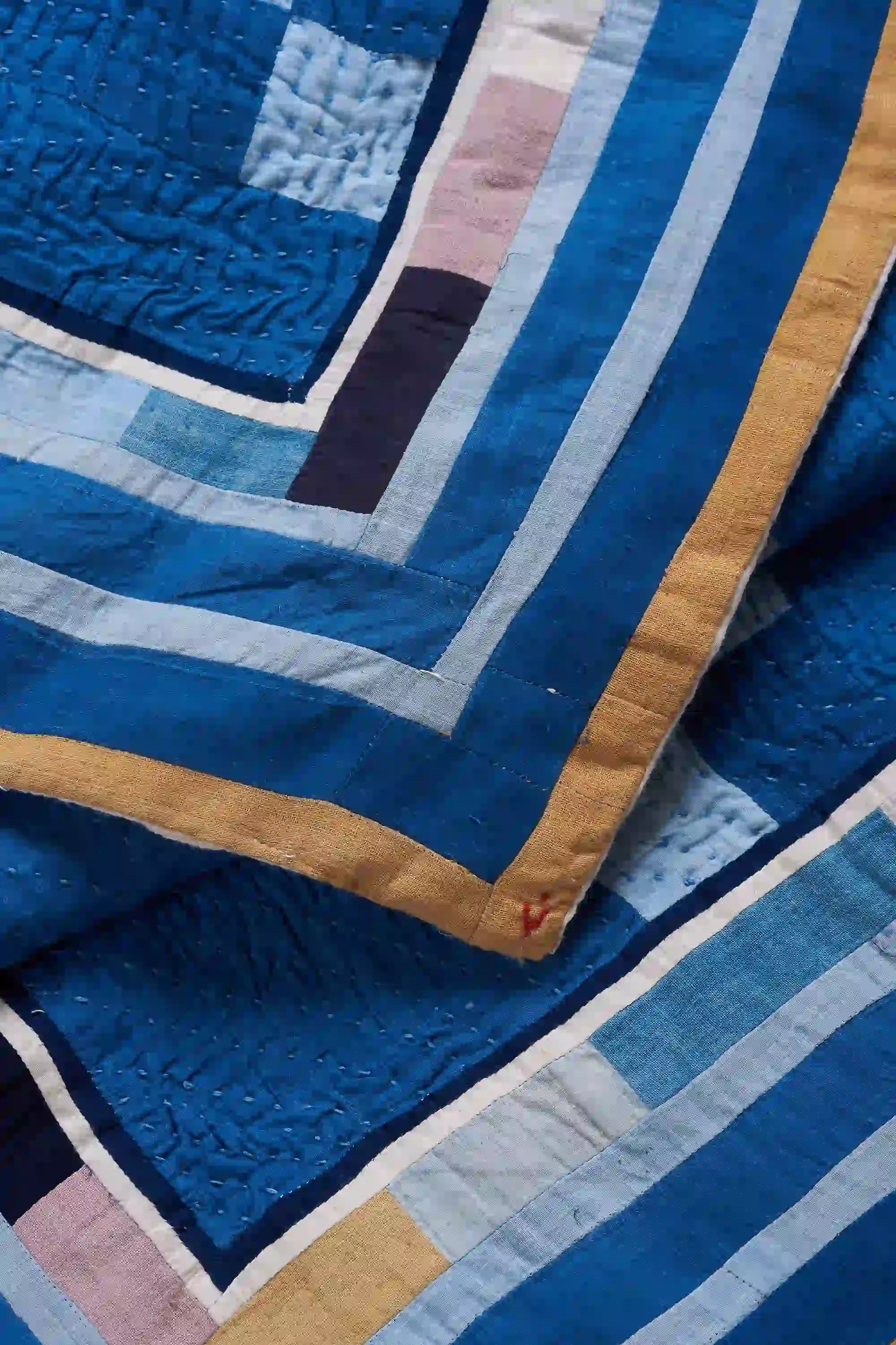 Close-up of a quilt with blue and brown patterns