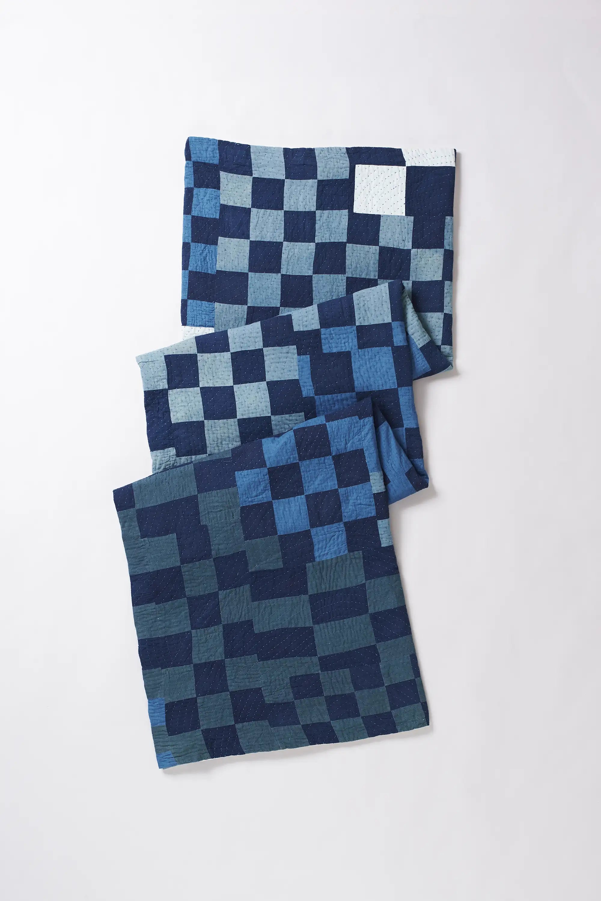 Folded fabric with white and indigo pattern on a white background