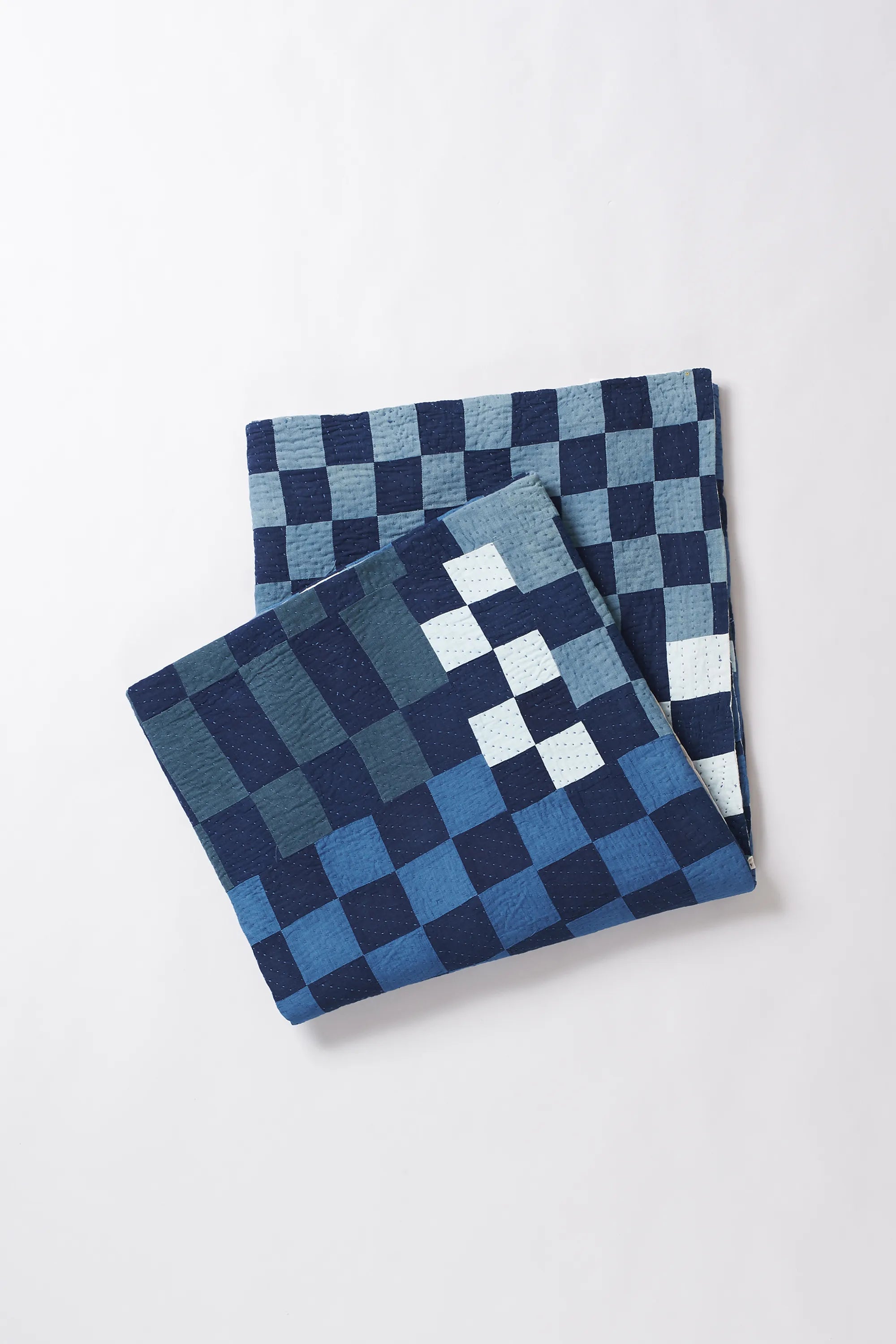 Folded fabric with white and indigo pattern on a white background