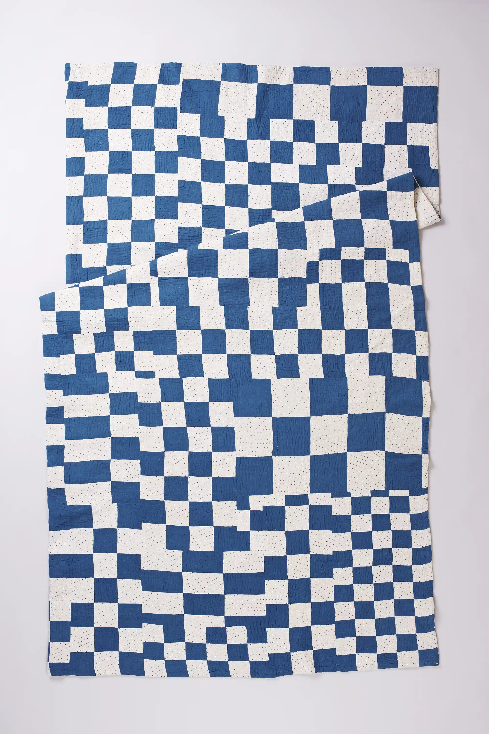 Blue and white checkered fabric on a light gray background