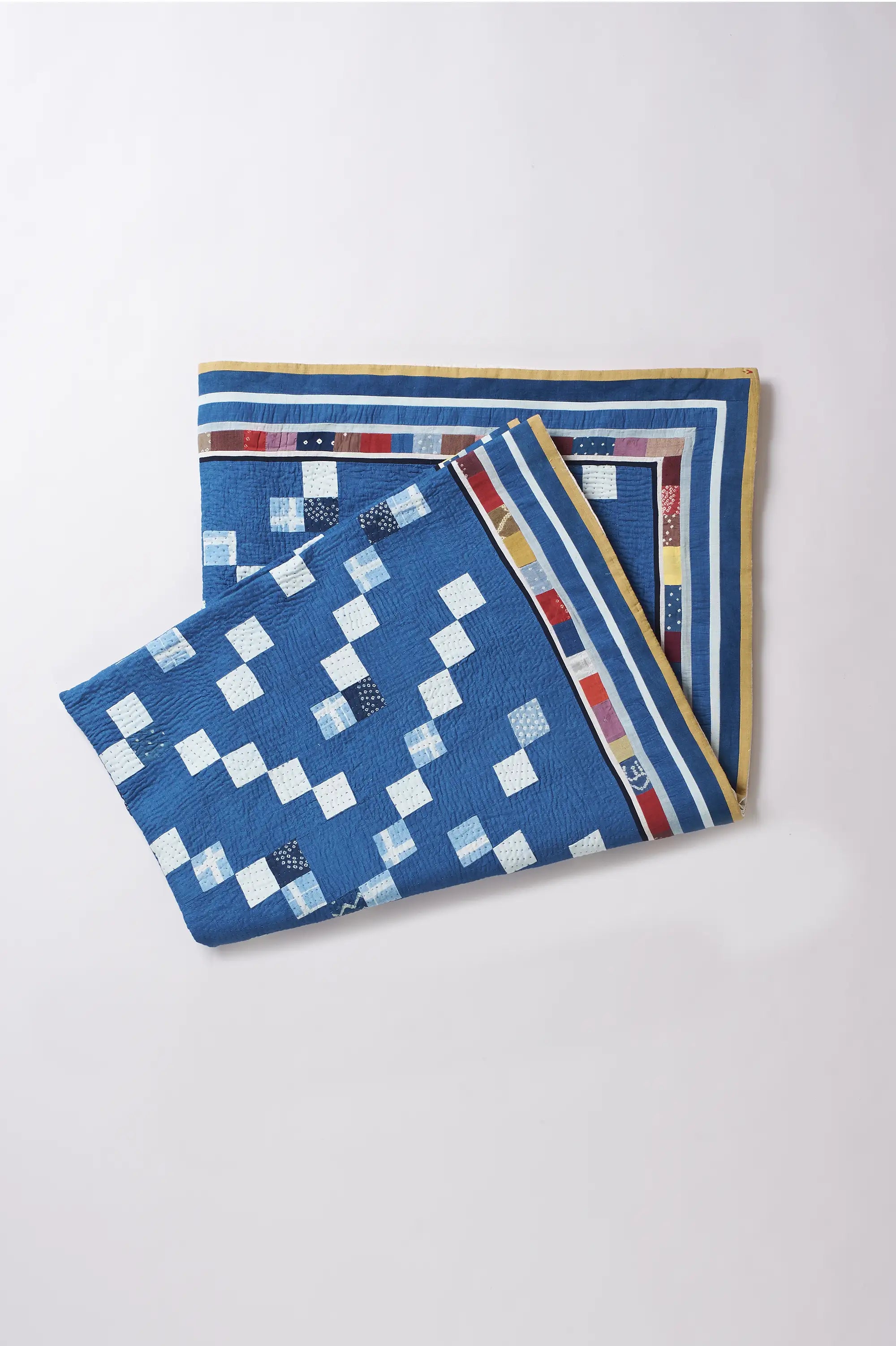 Blue checkered fabric with patterned border on a light gray background