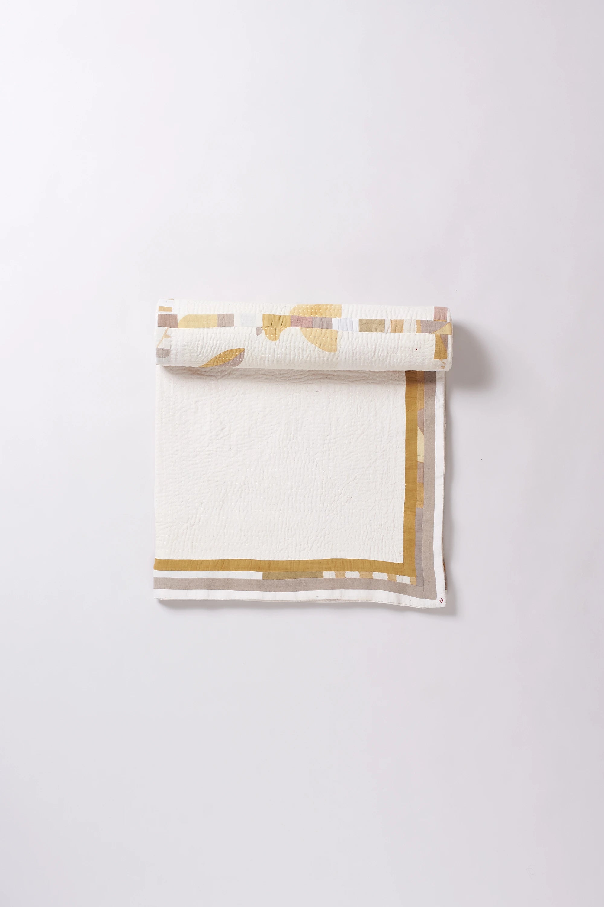 Colorful patterned fabric roll on a white background