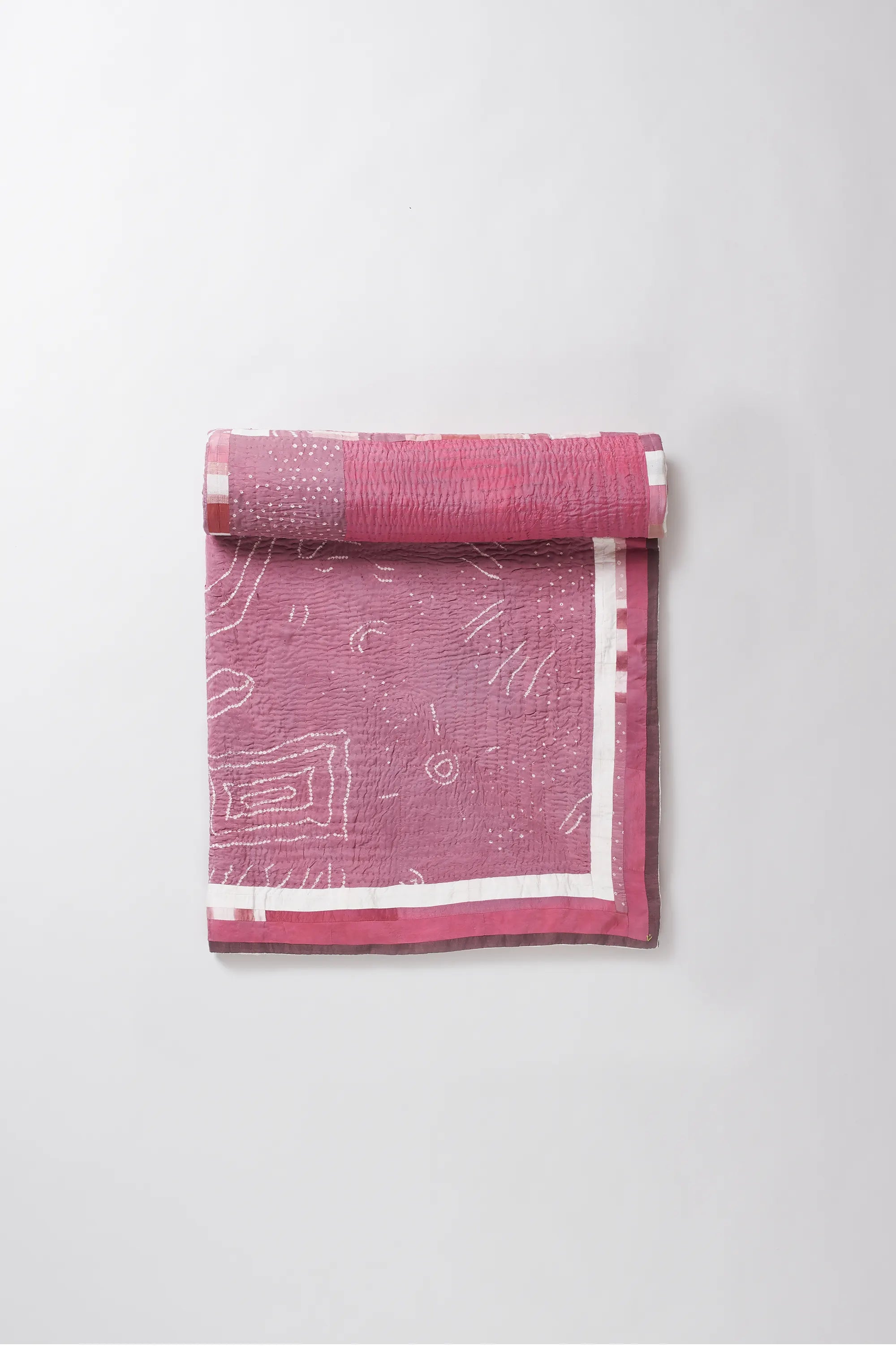 Pink yoga mat with white patterns on a light gray background