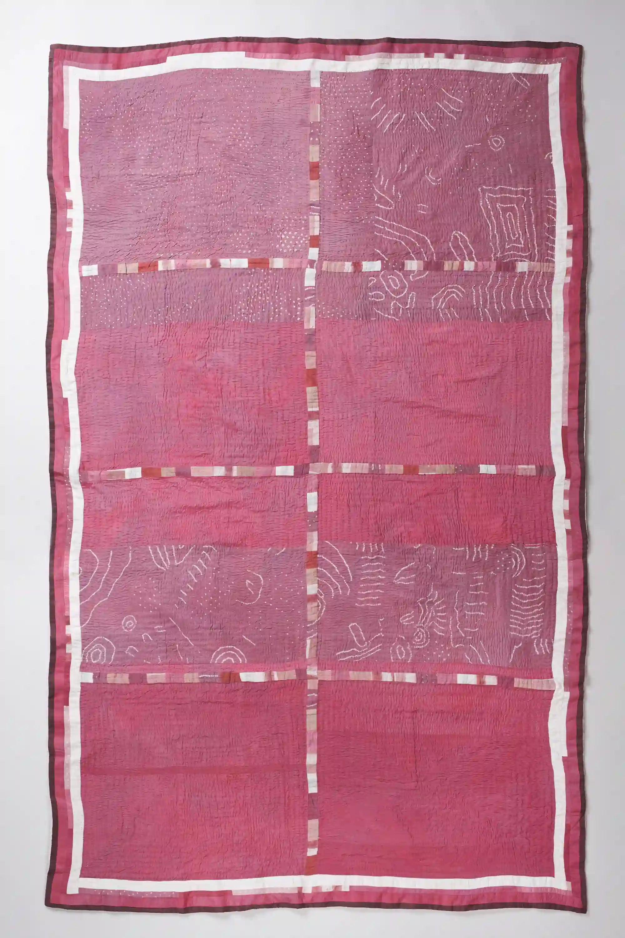 Pink fabric with white patterns on a white background