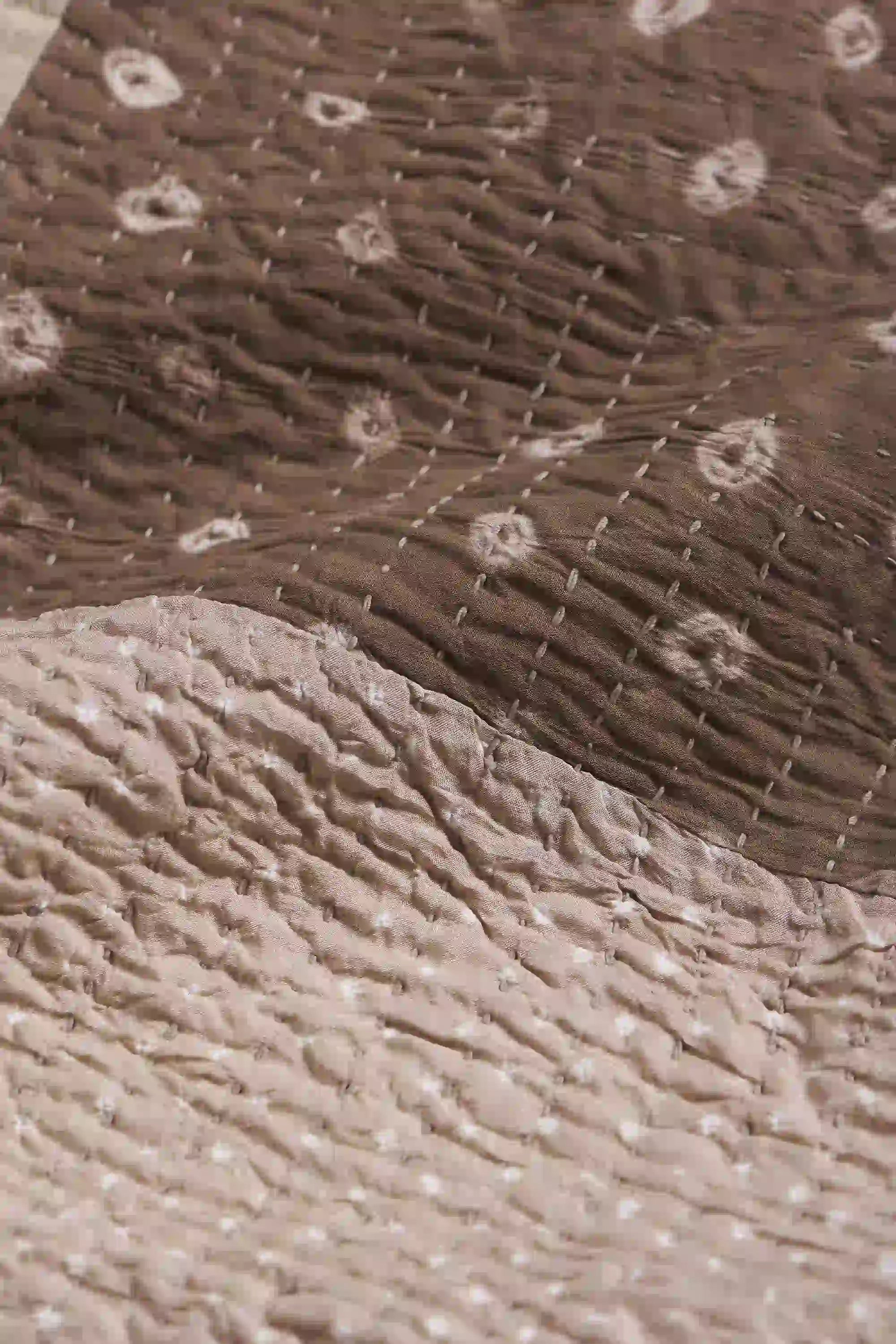 Close-up of textured brown fabric with a subtle pattern