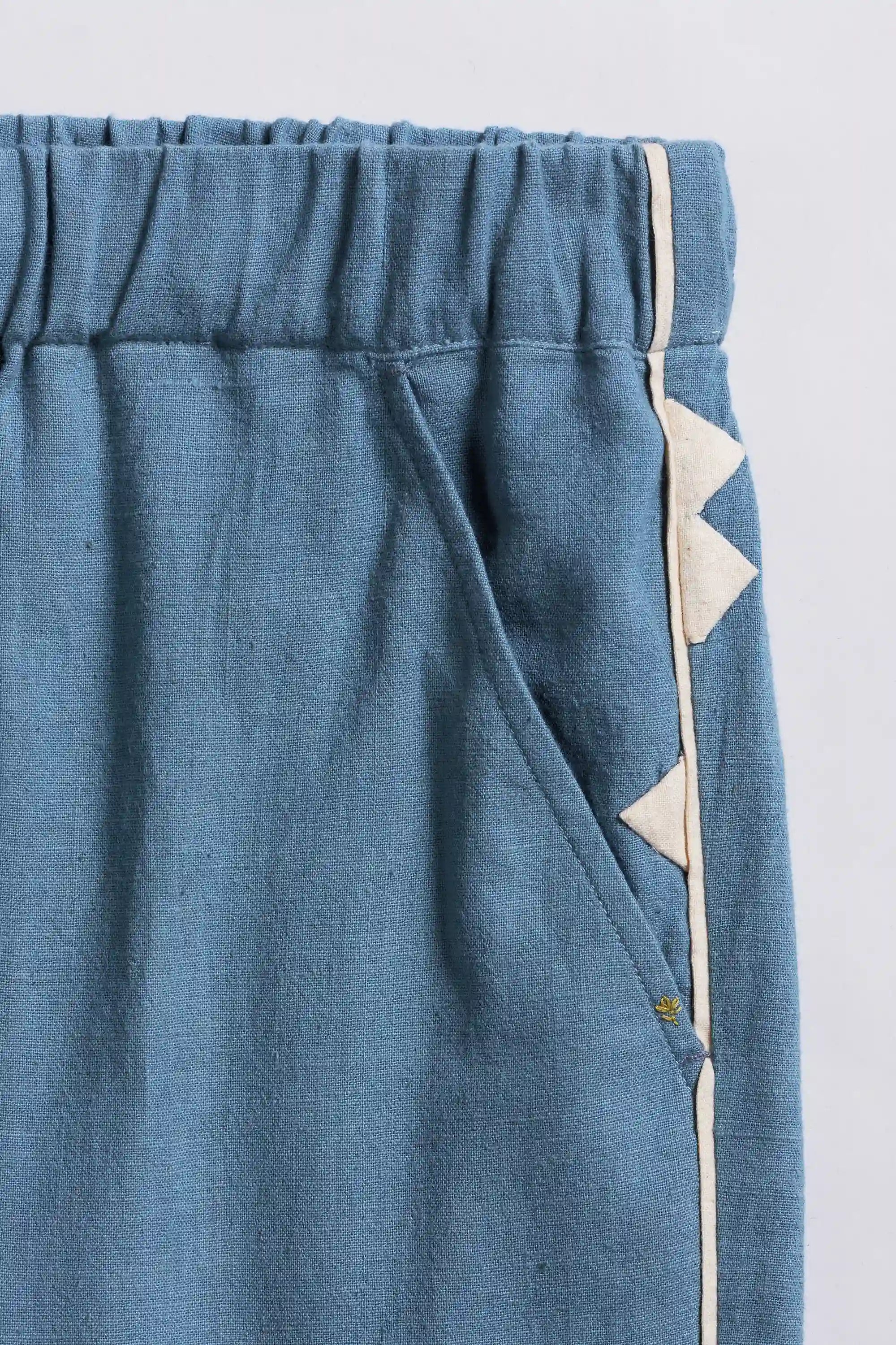Fabric close-up with white triangle patterns with pocket on a white background