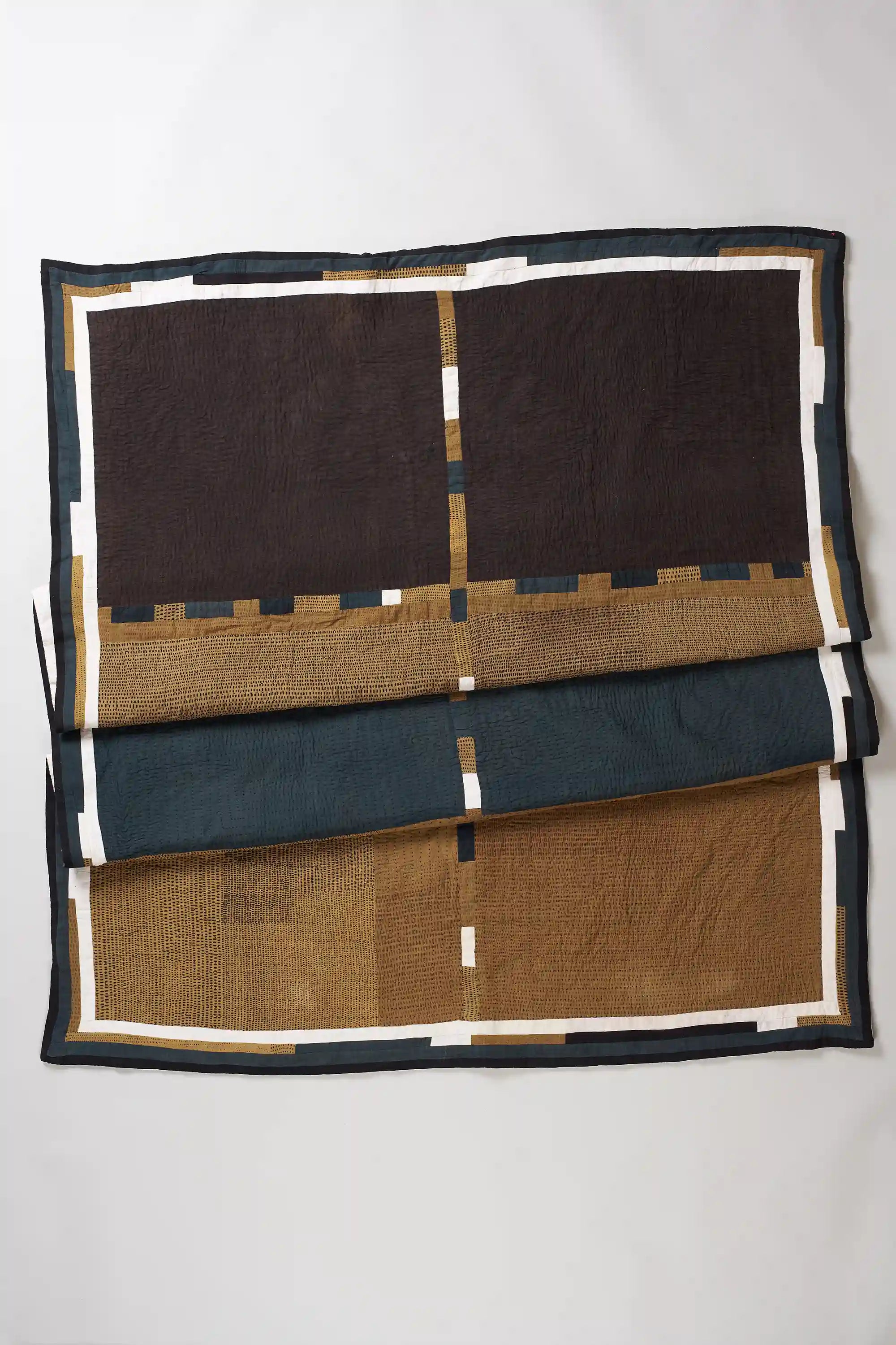 Folded black patchwork quilt