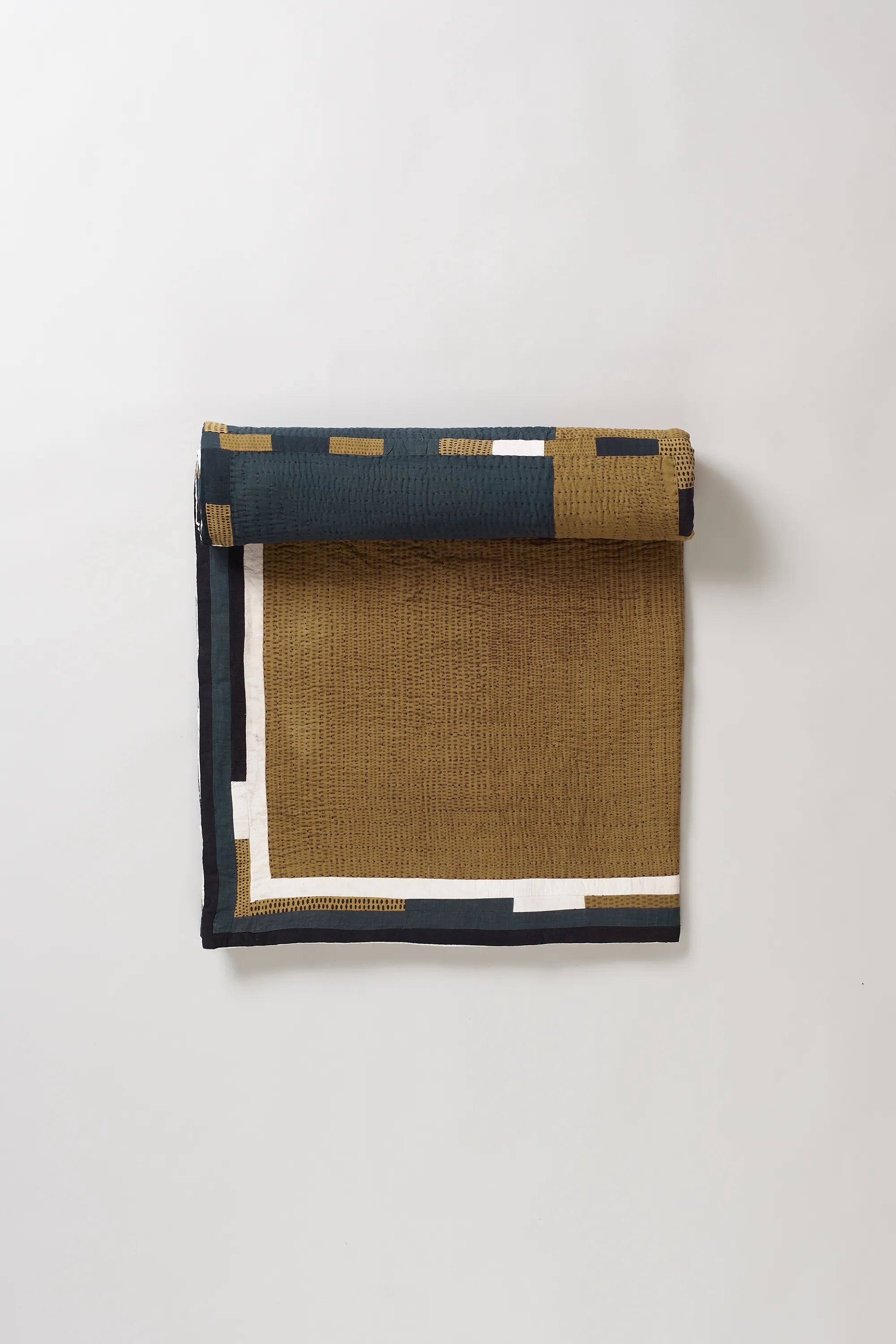 Black quilt roll on light grey background