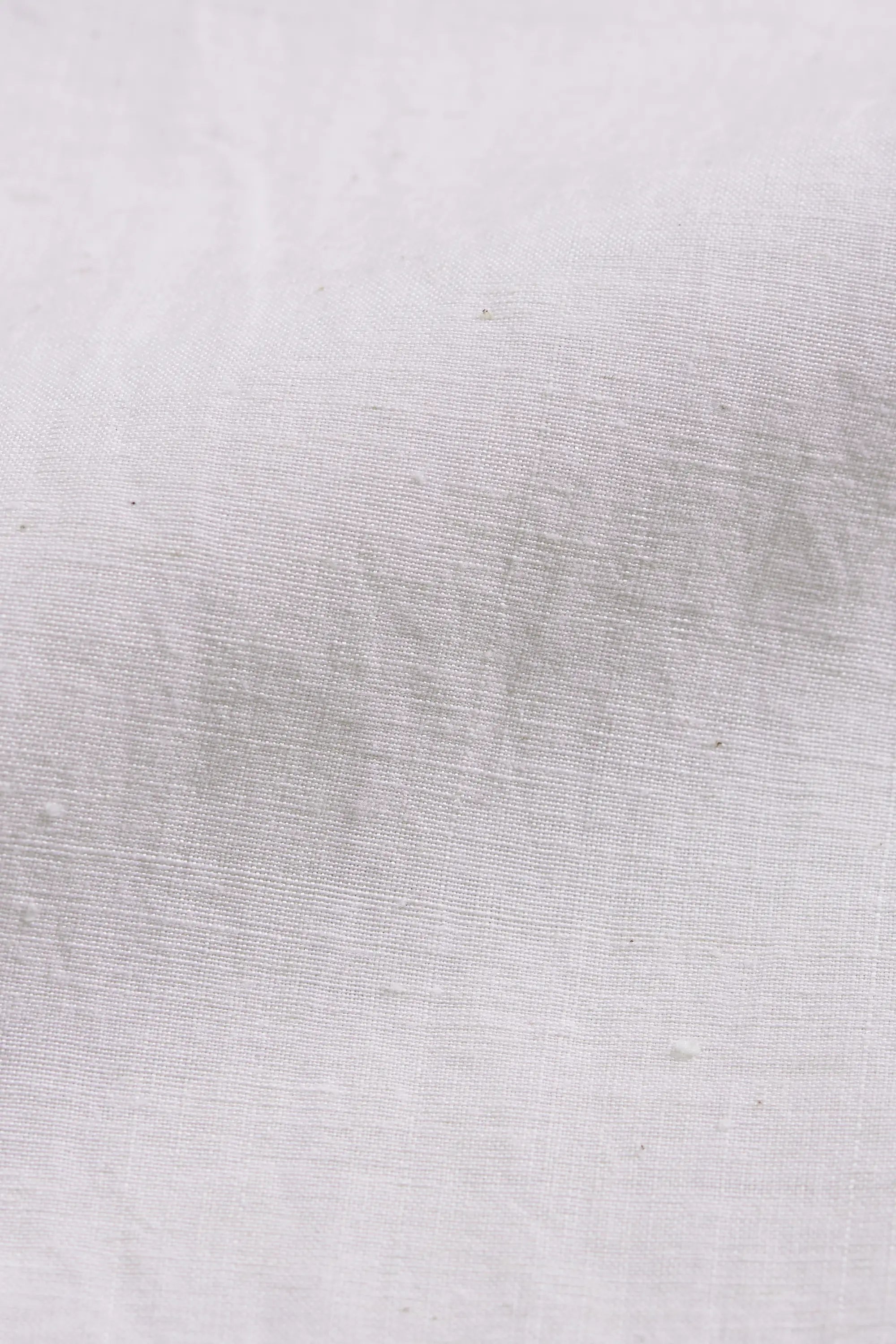A close-up ecru fabric.