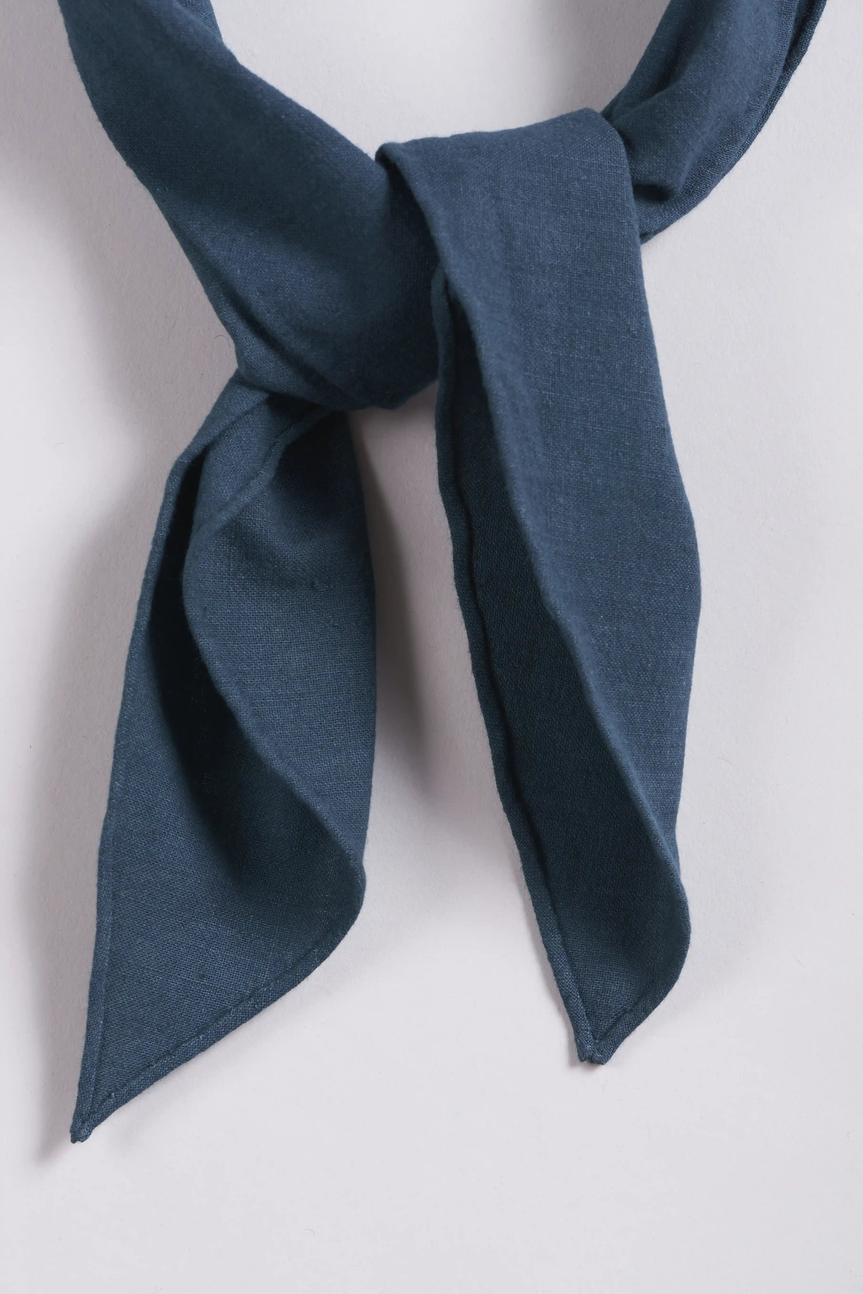 Blue scarf tied in a knot on a white background