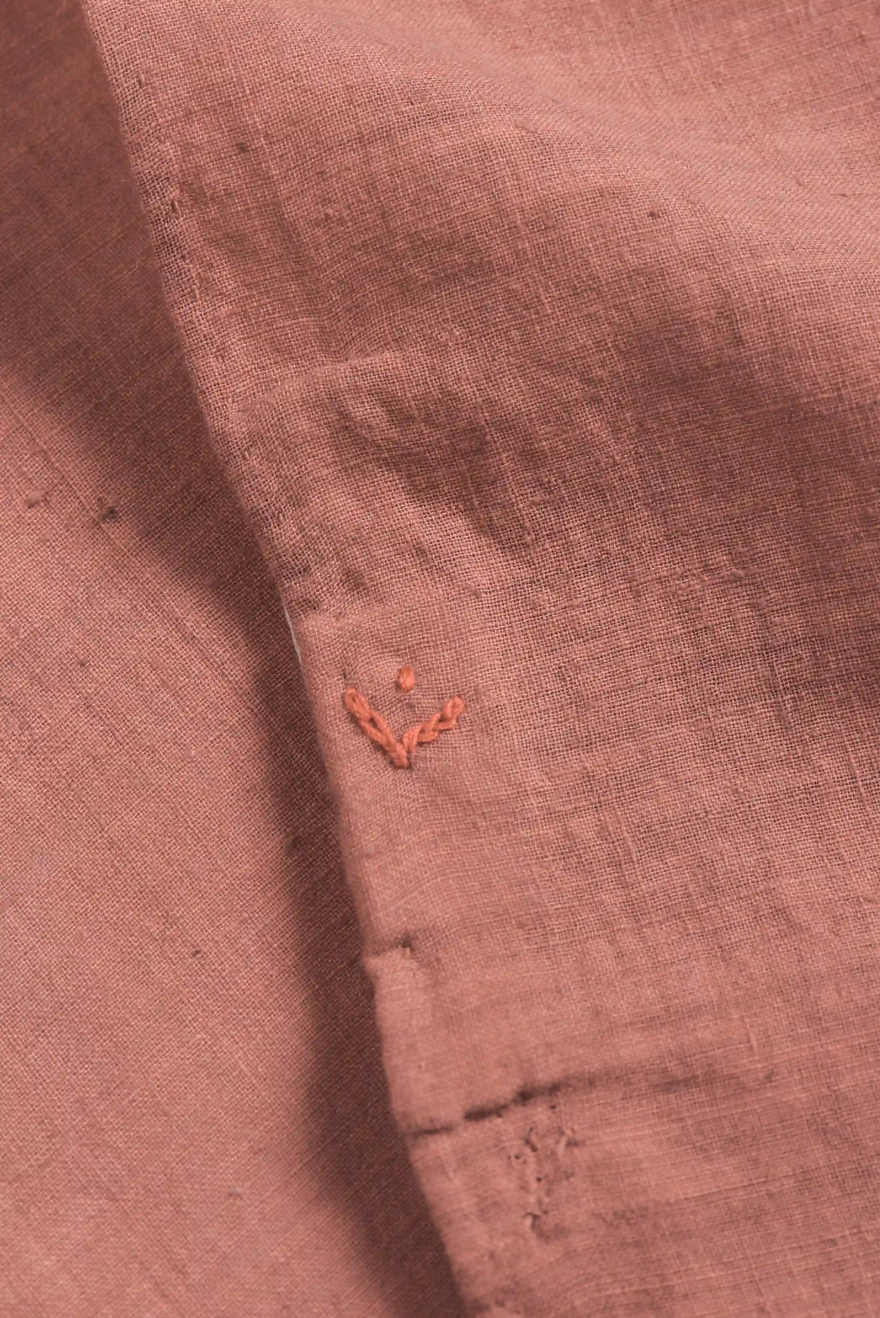 Close-up of a folded piece of pink bandana with red small pehchan 
