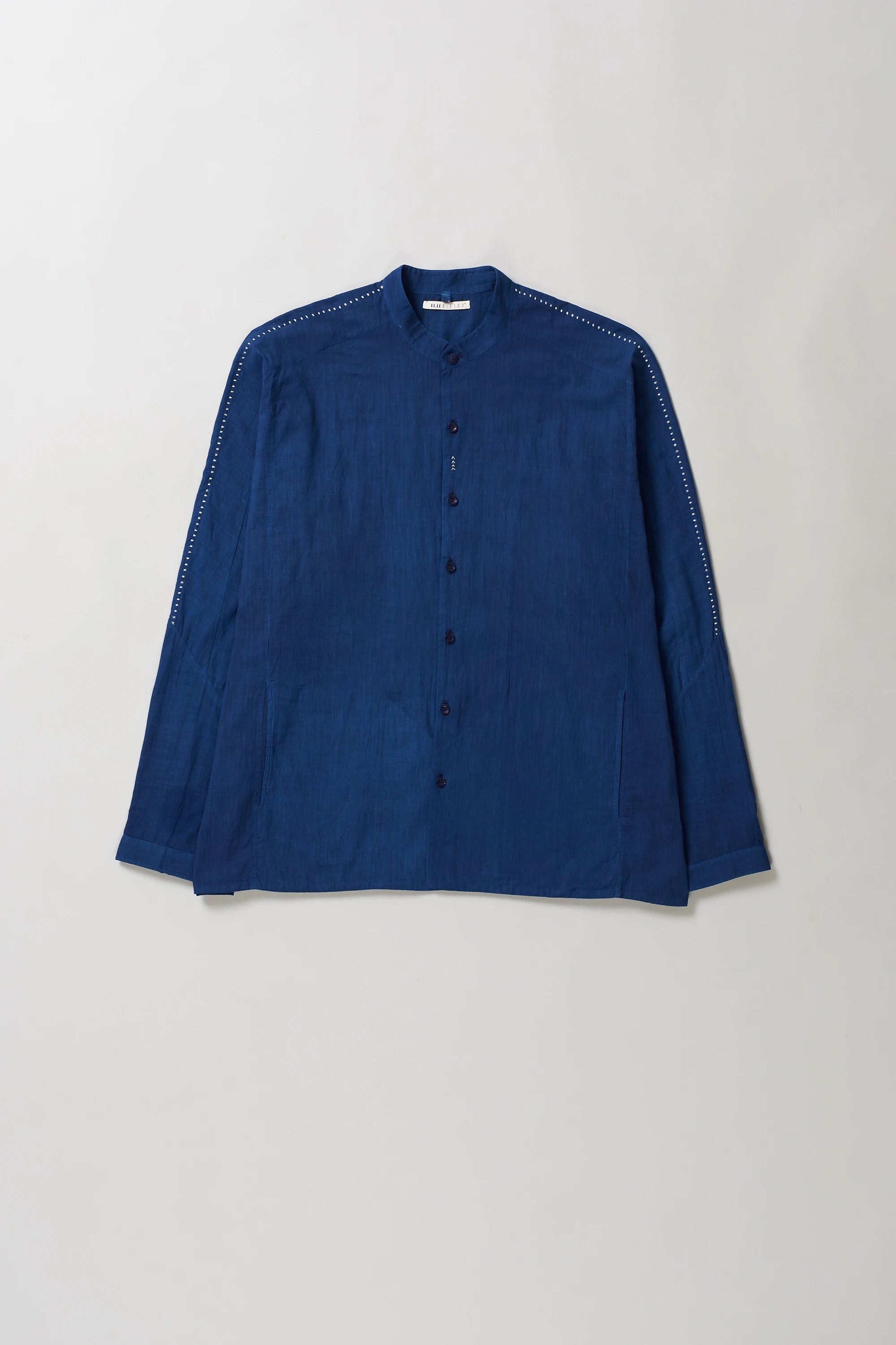 Blue cotton shirt on a light grey background