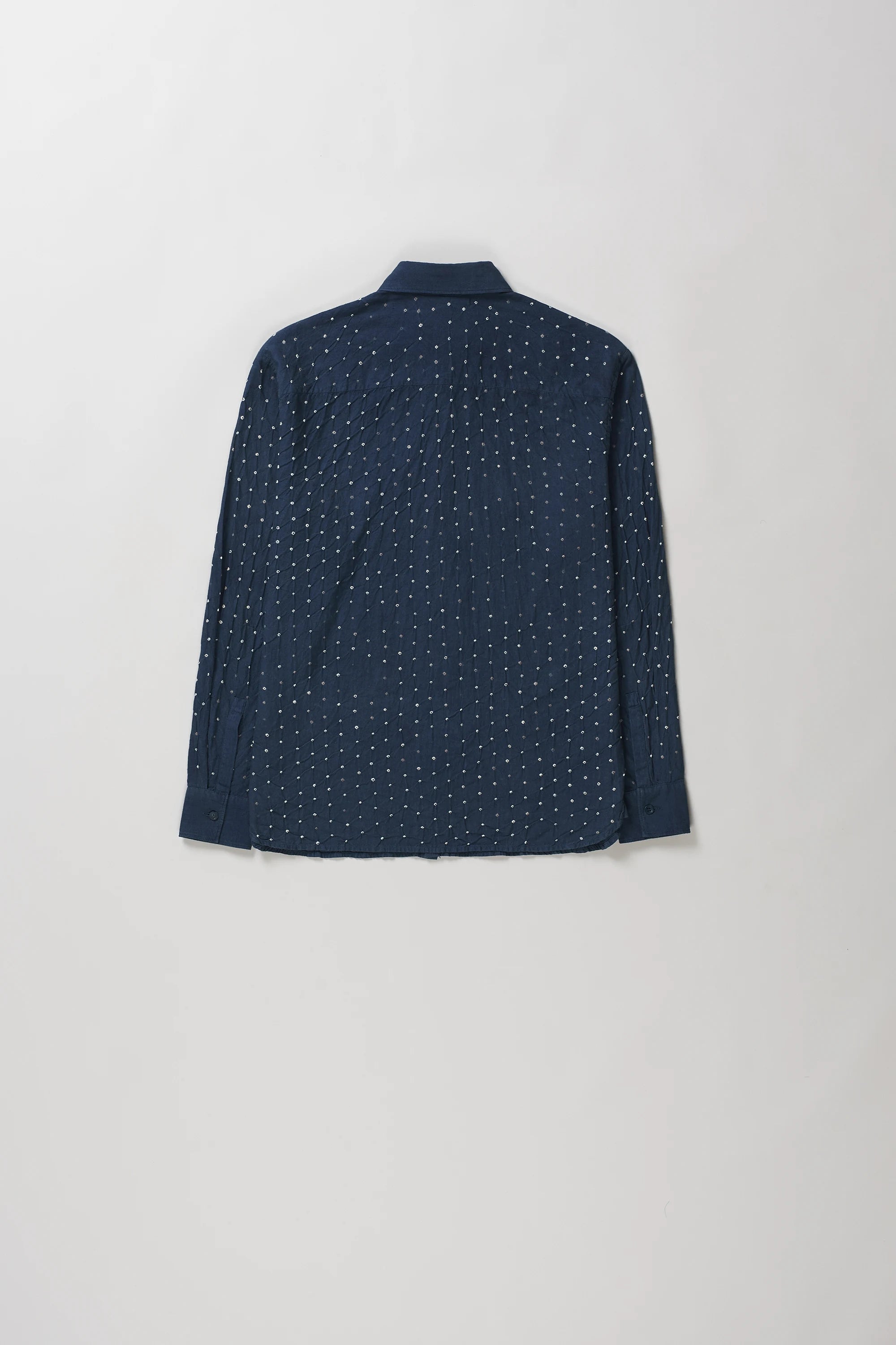 Back shot of space blue long-sleeve button-up shirt with a fine white dotted pattern, laid flat against a light grey background.