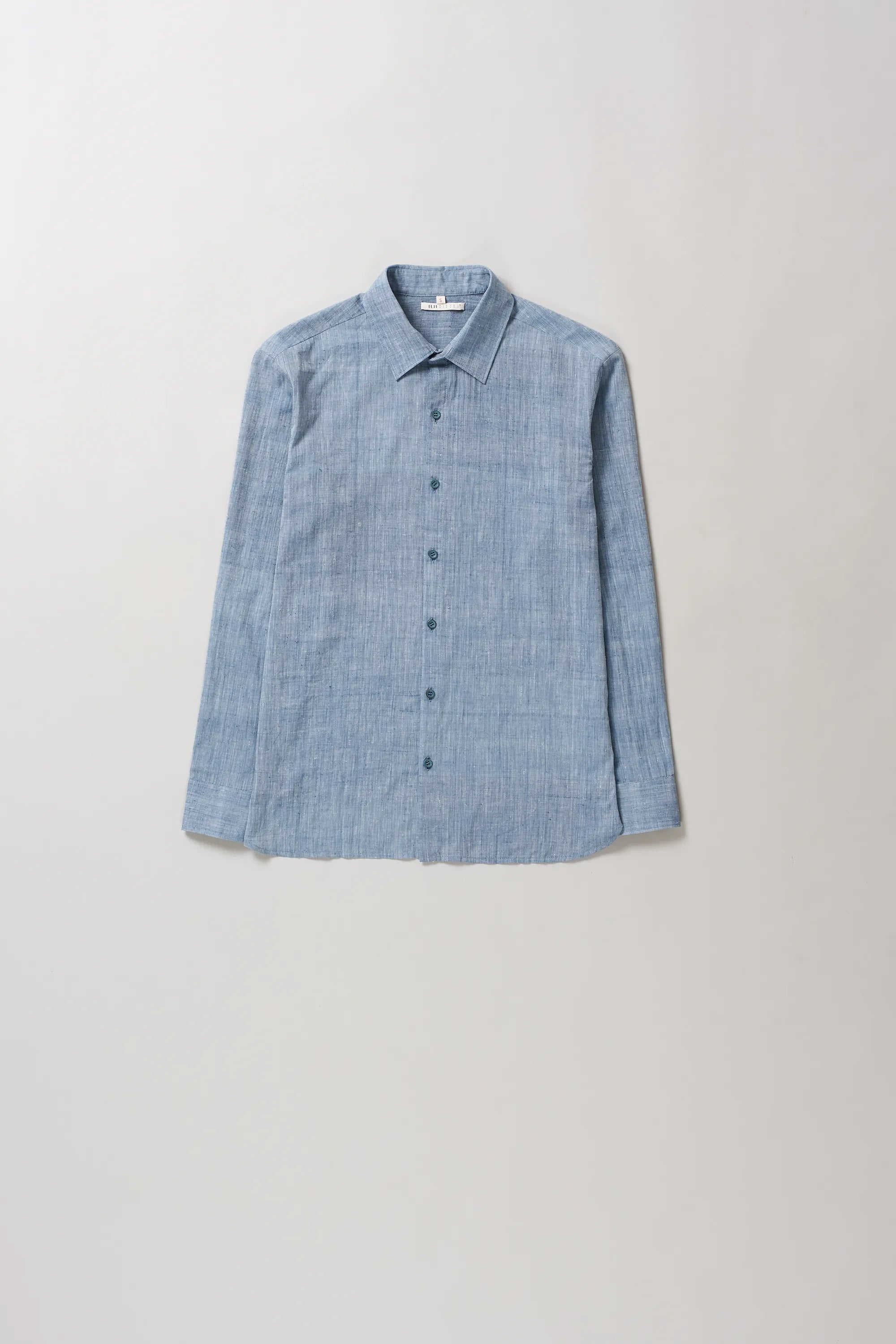 Blue shirt on a light grey background