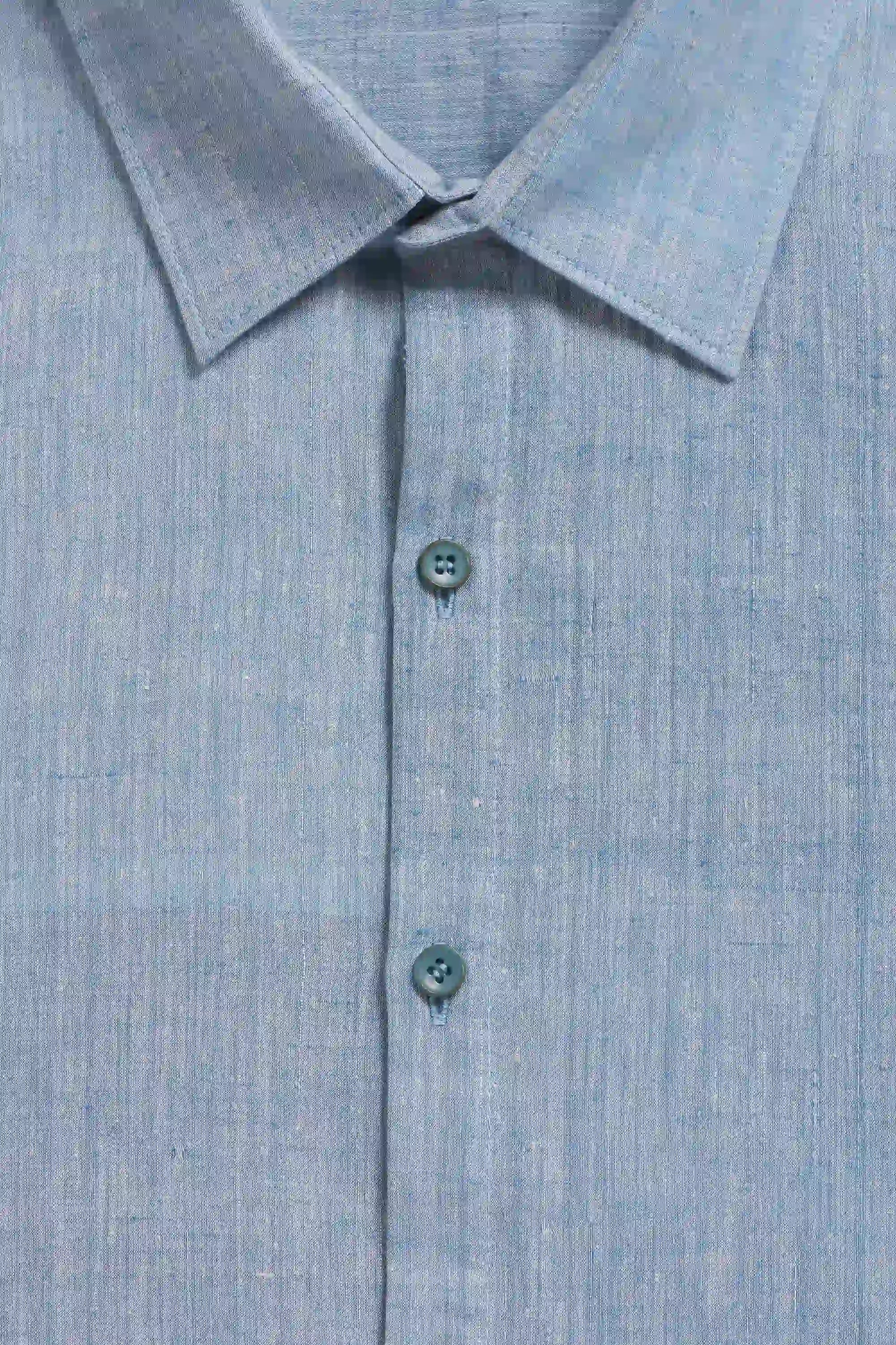 Close-up of a blue shirt with a collar and buttons.