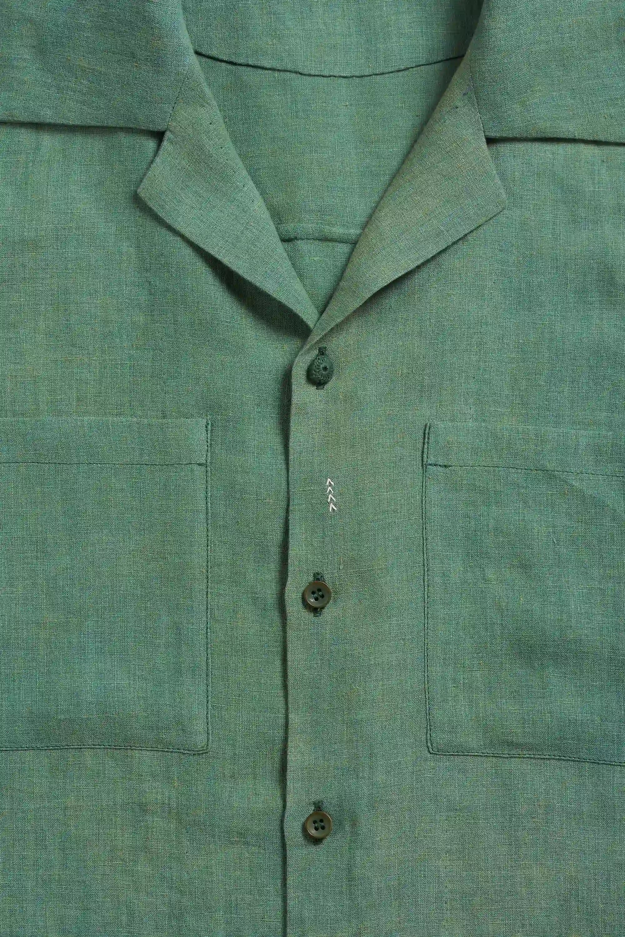 Close-up of a green shirt with collar and buttons 
