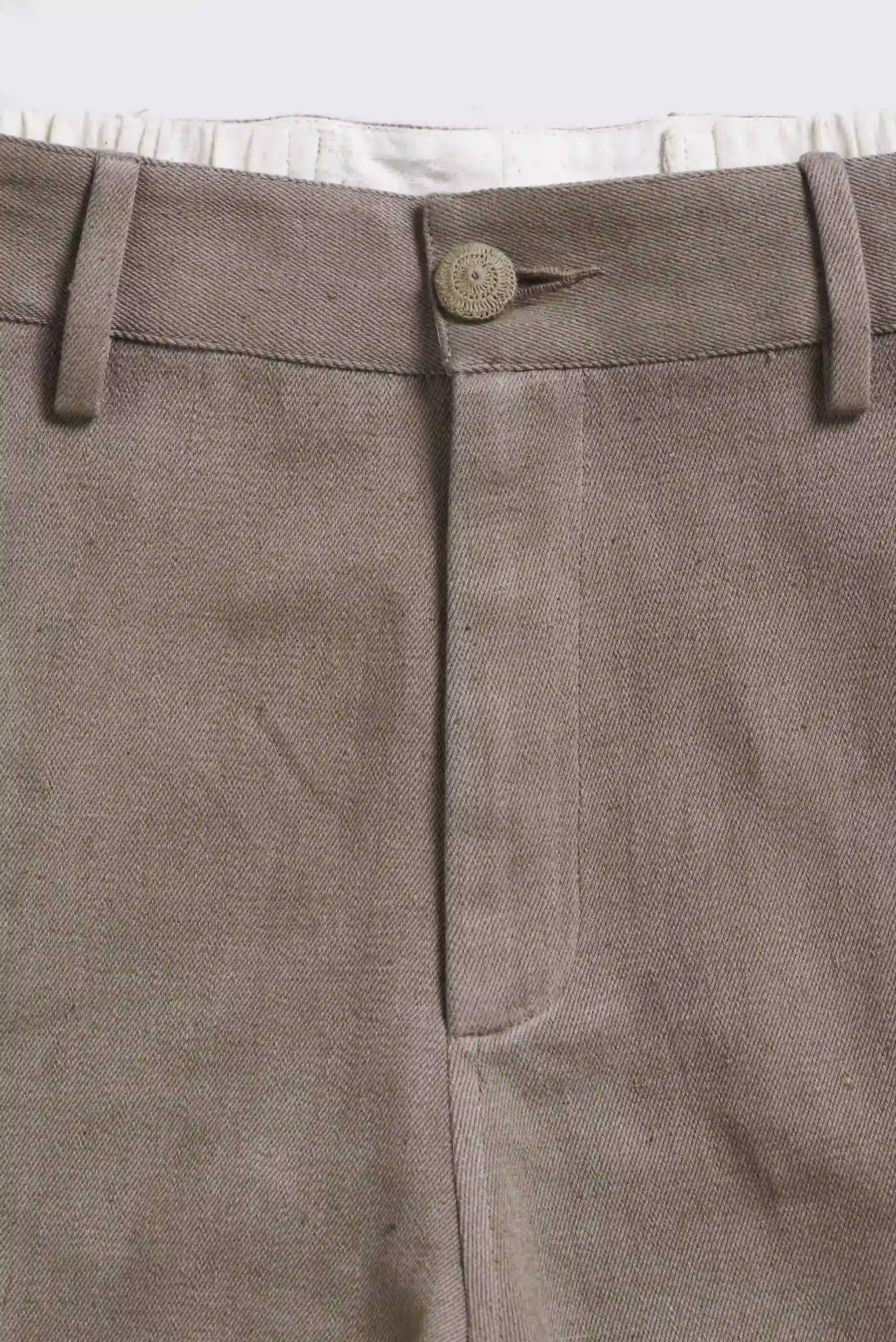 Close-up of a fabric with button on a light grey background