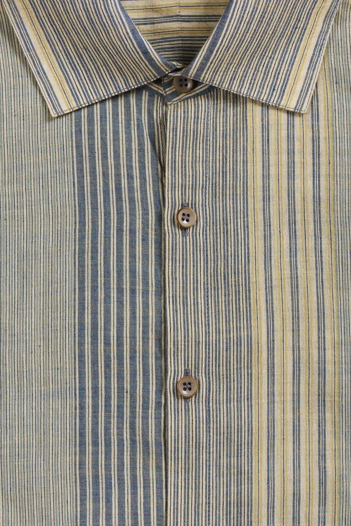 Close-up of a striped button-down shirt collar and front placket, featuring vertical stripes in muted blue, beige, and cream with brown buttons.