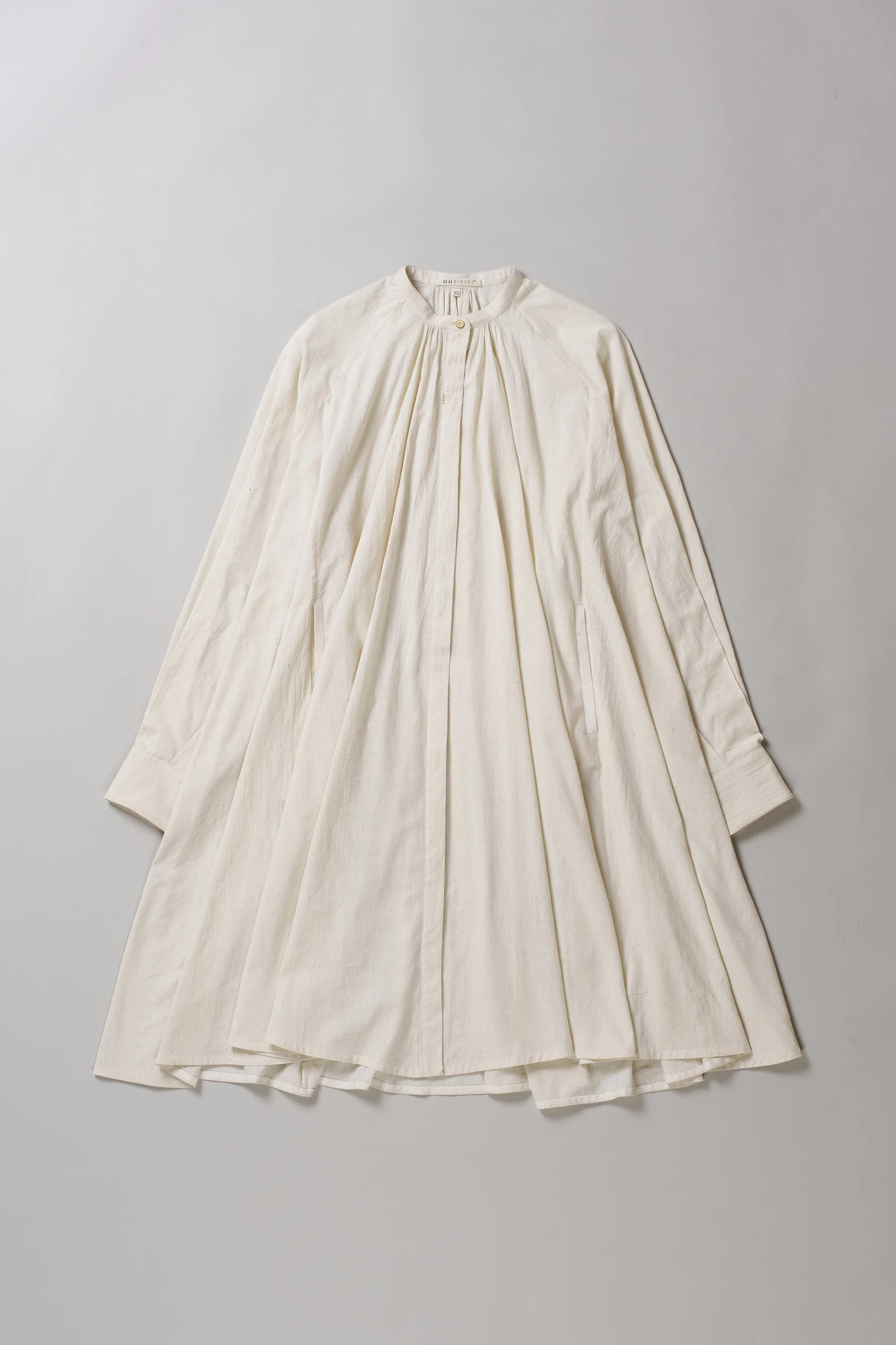 Front image of ecru dress on a grey background