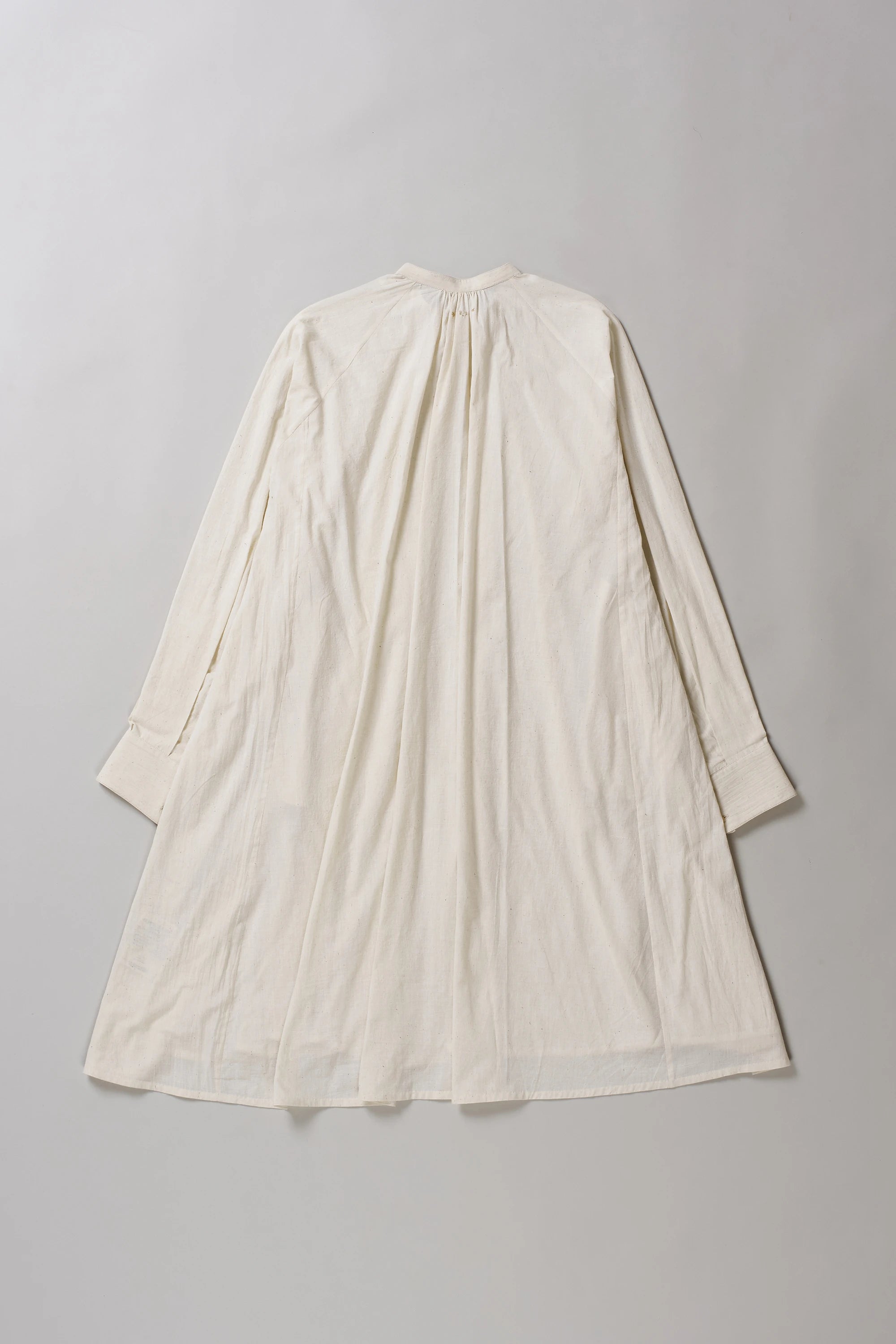 Ecru dress on a grey background