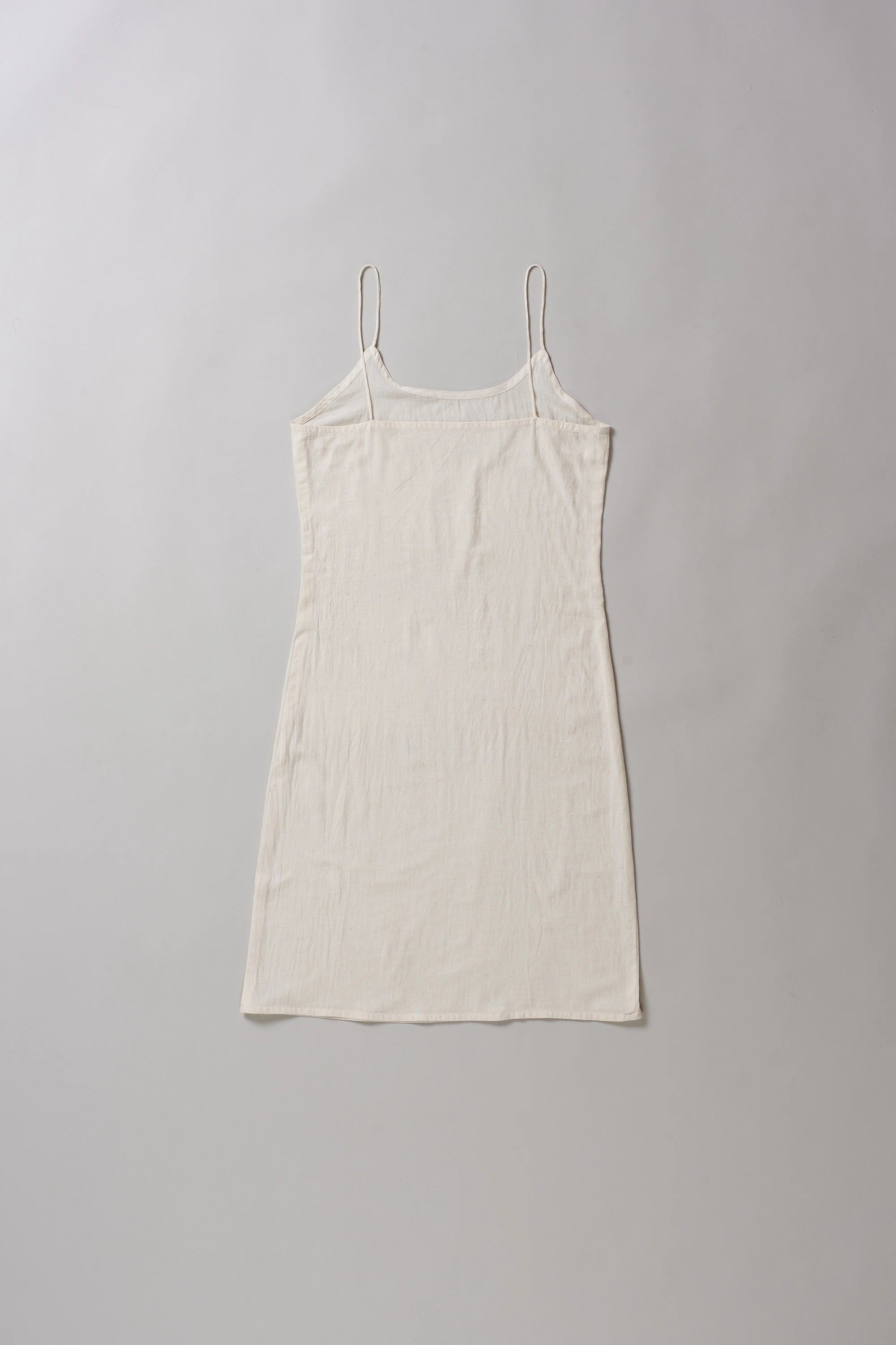 Back image of ecru slip dress on a grey background