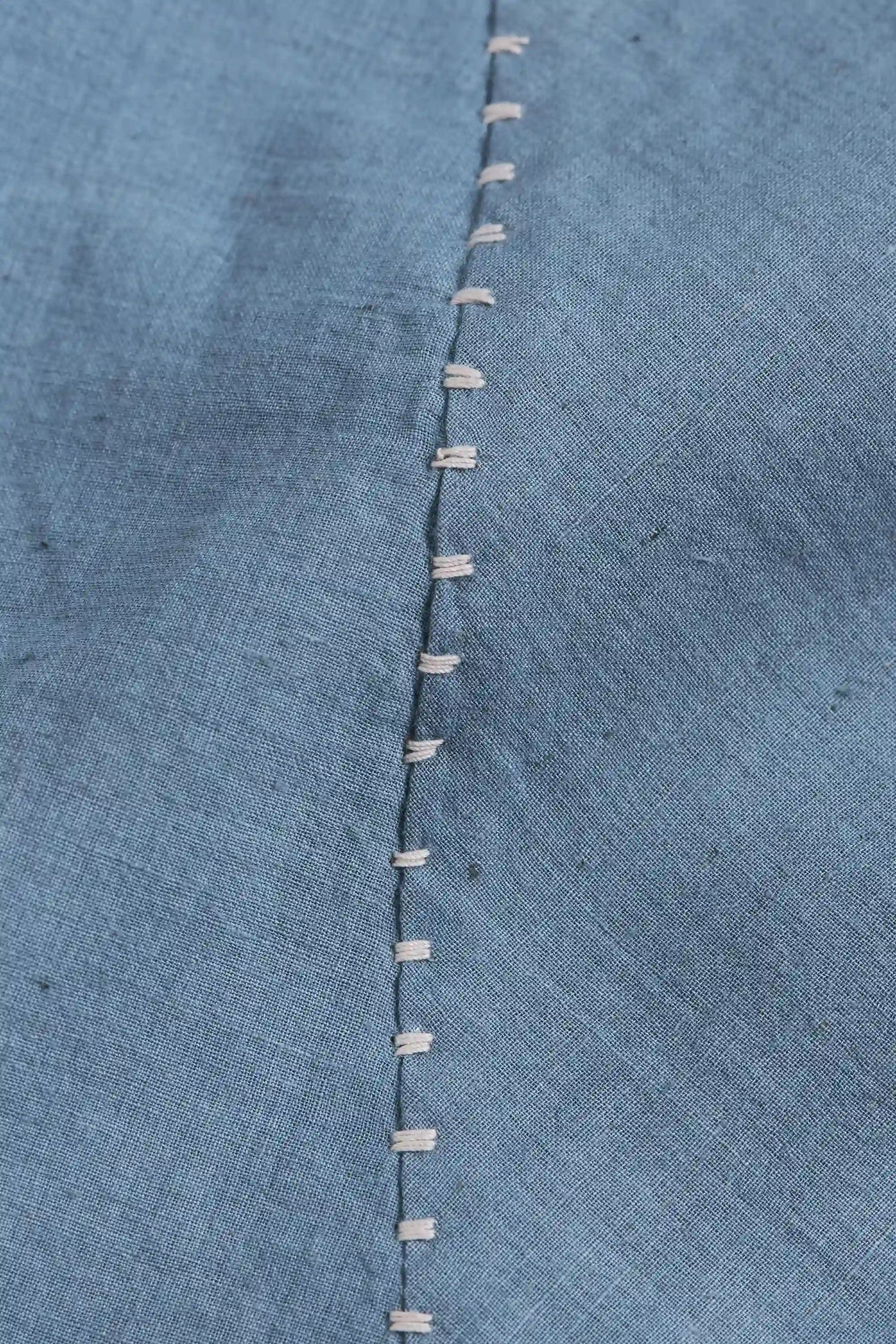 Close-up of a blue cotton fabric with hand detailing