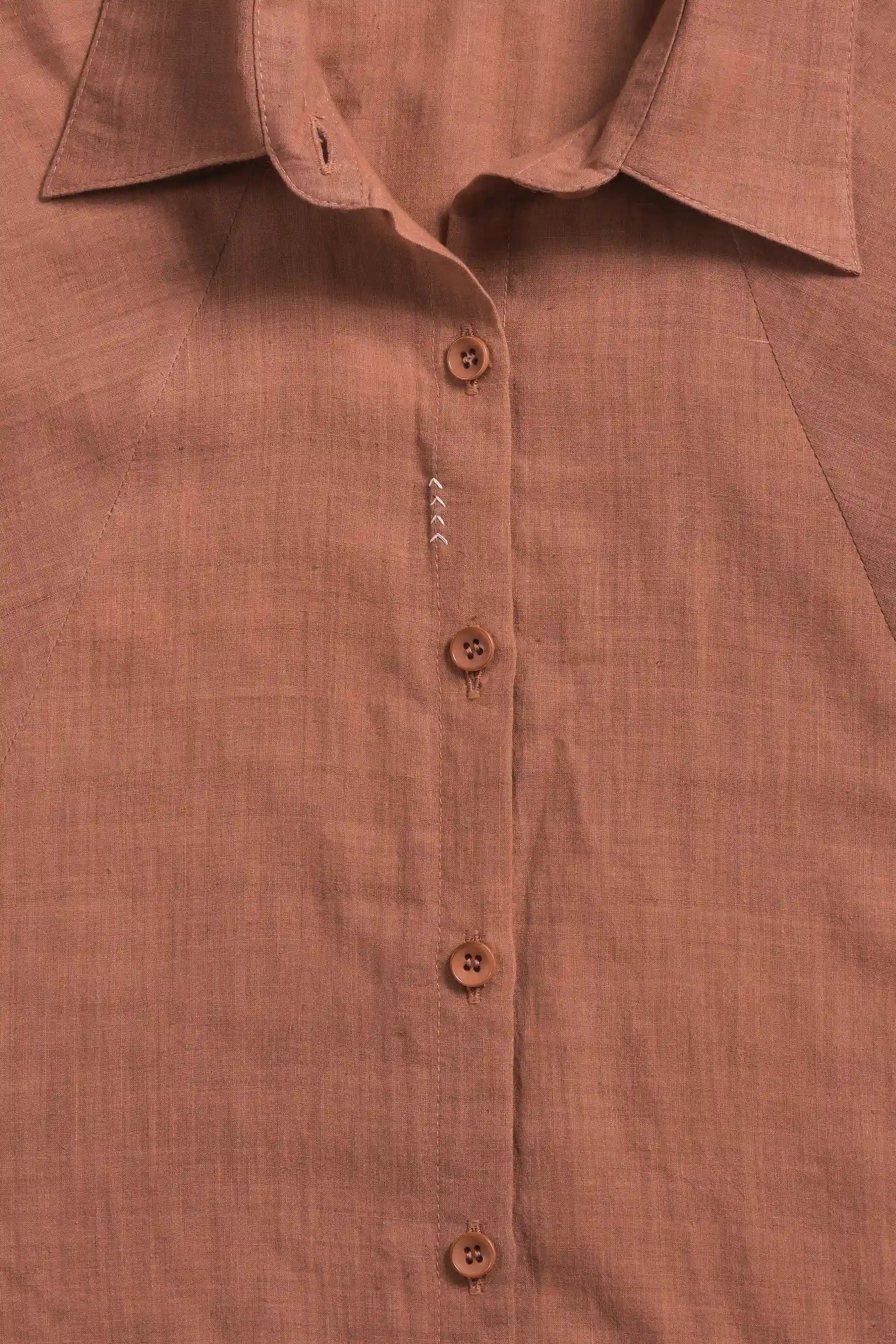 Close-up of a fabric with buttons and  a collar