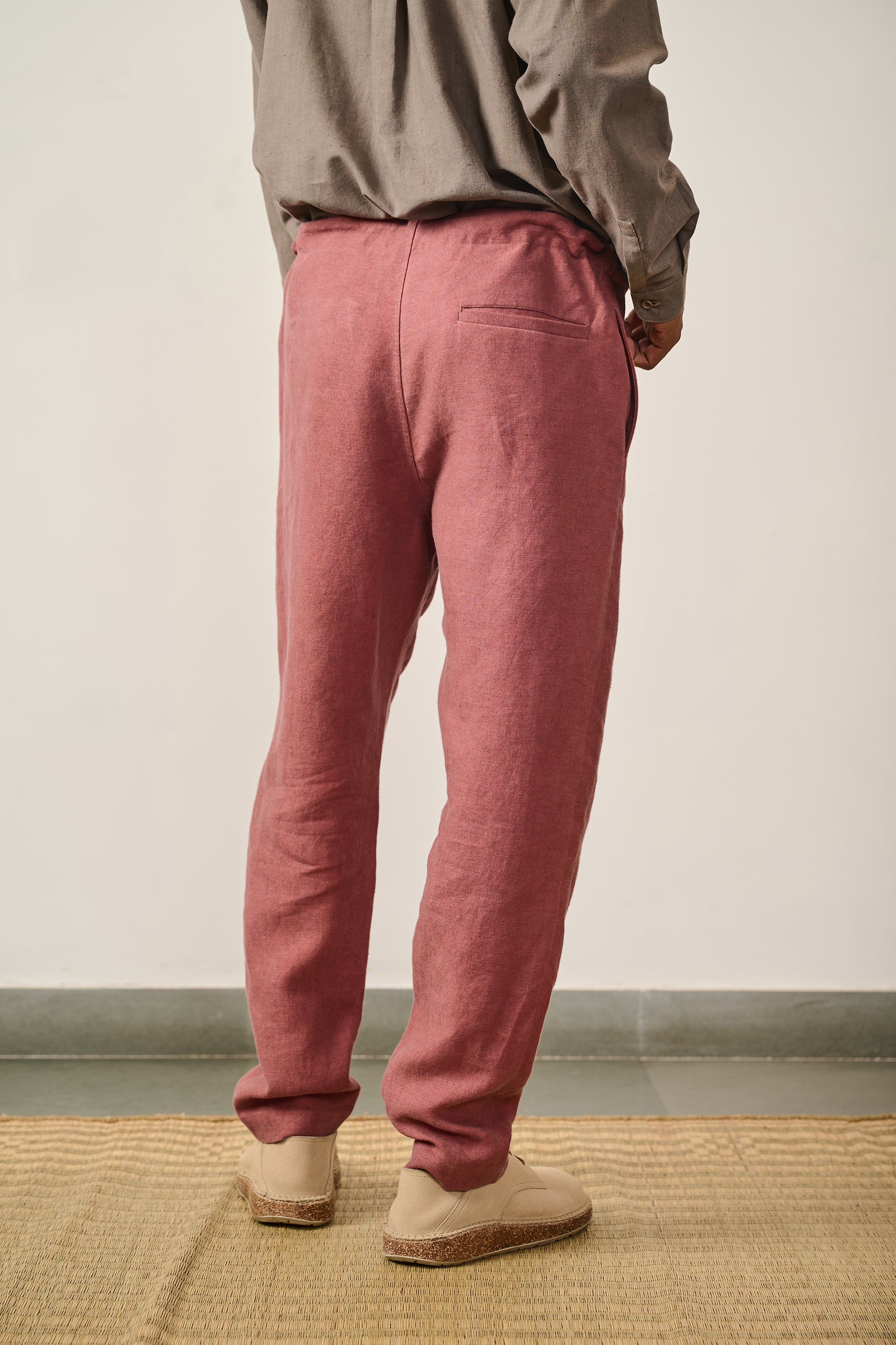 A back shot of a man wearing rouge pink pant
