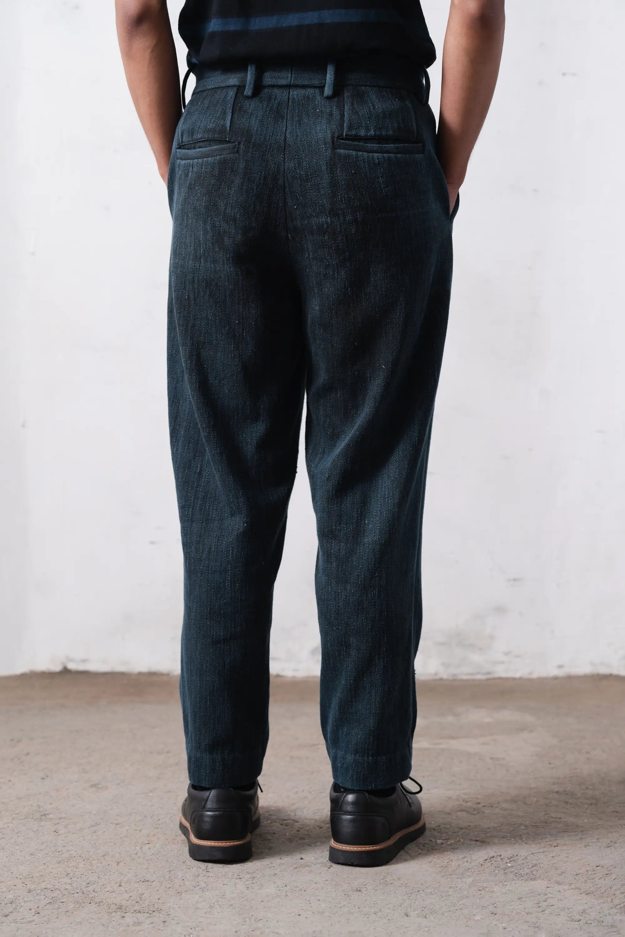Back shot of a person wearing midnight indigo pant